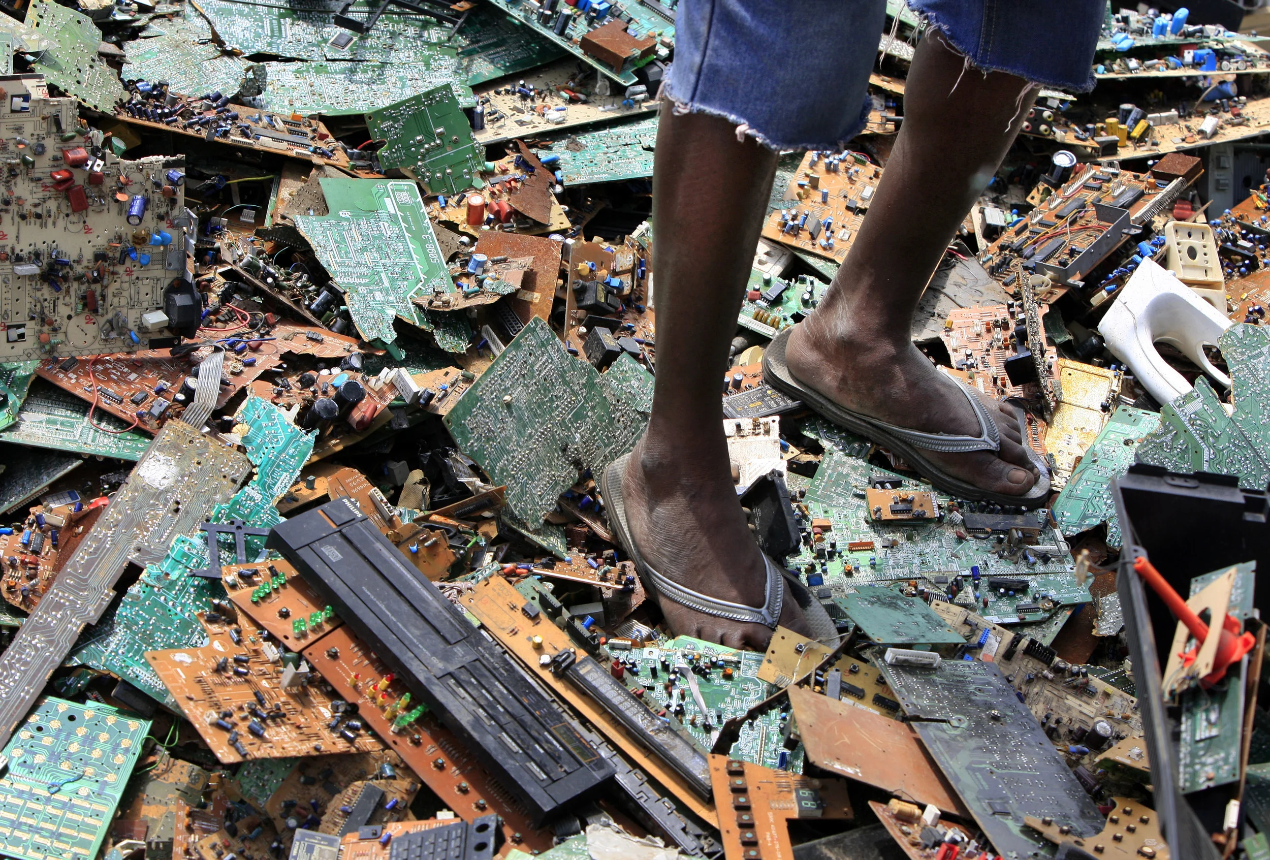 Discarded circuit boards of computers that have been re-cycled, with catastrophic environmental consequences. Agbogbloshie, Ghana, July 2009.