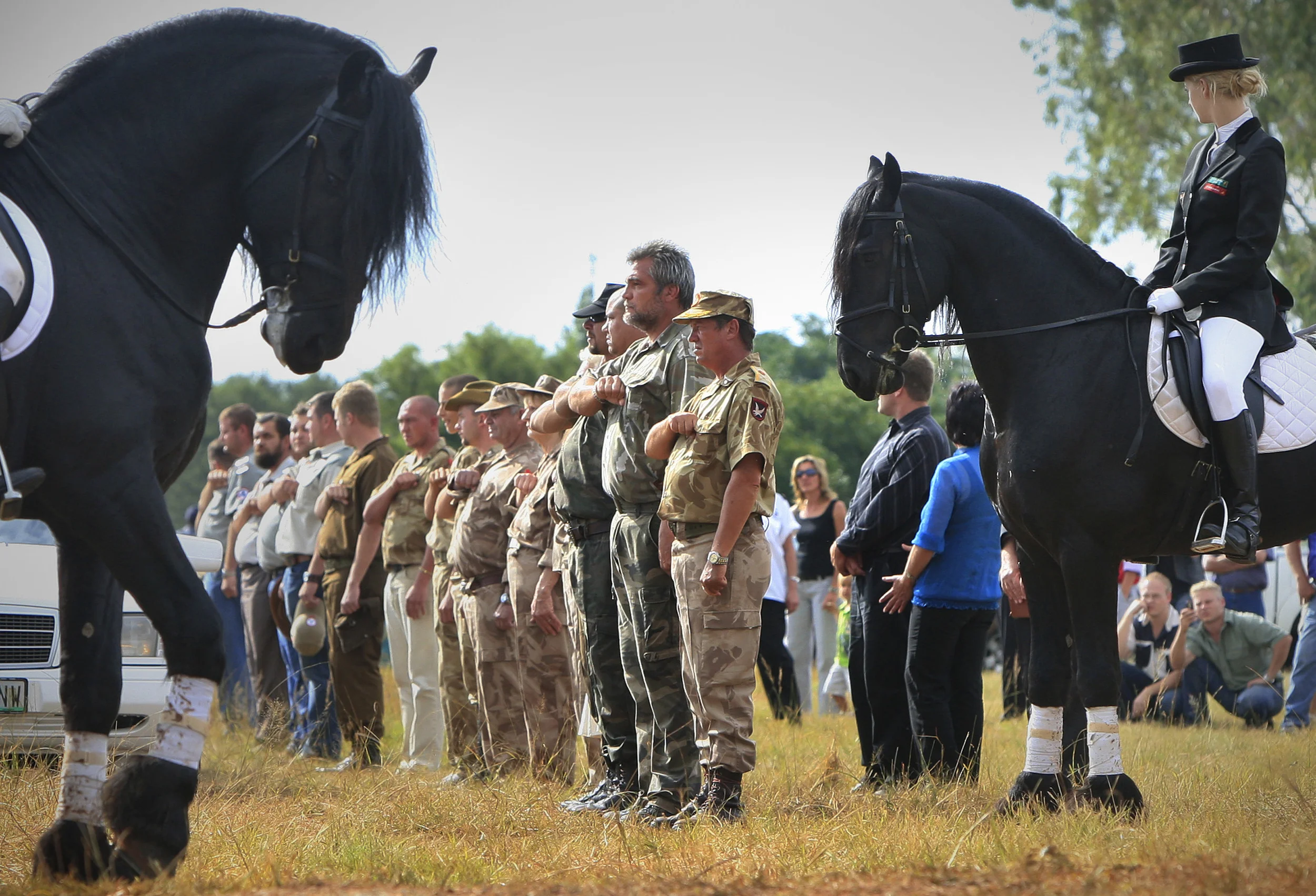 Supporters and mourners of AWB founder, Eugene Terre Blanche, stand to attention at his burial, following his funeral service in Ventersdorp, South Africa. April 2010.