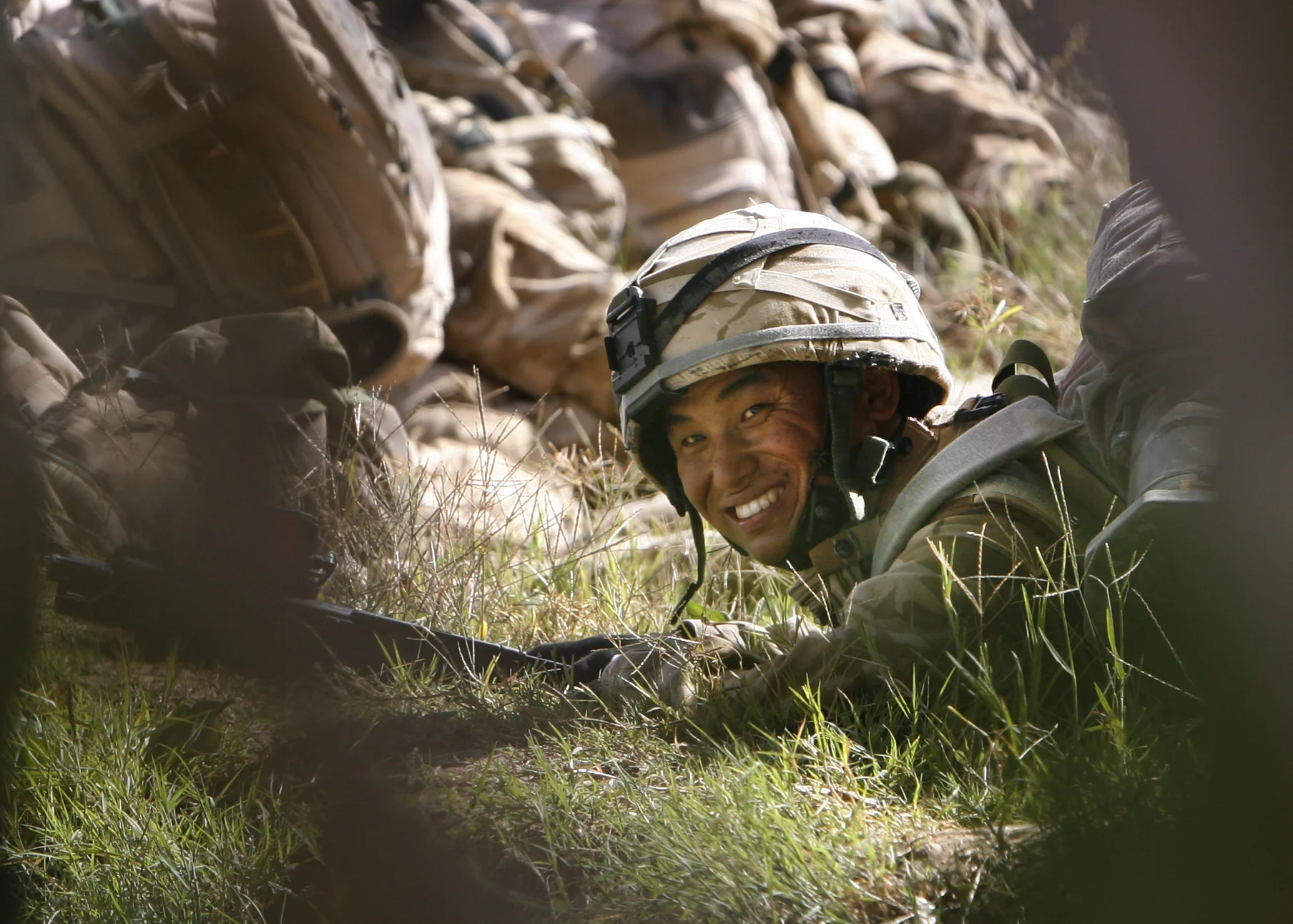 A rifleman of 'C' company, The Royal Gurkha Rifles, takes cover during a 'contact' with Taleban, in the 'Green Zone' area of Hydarabad, Helmand Province, Afghanistan. September, 2007.
