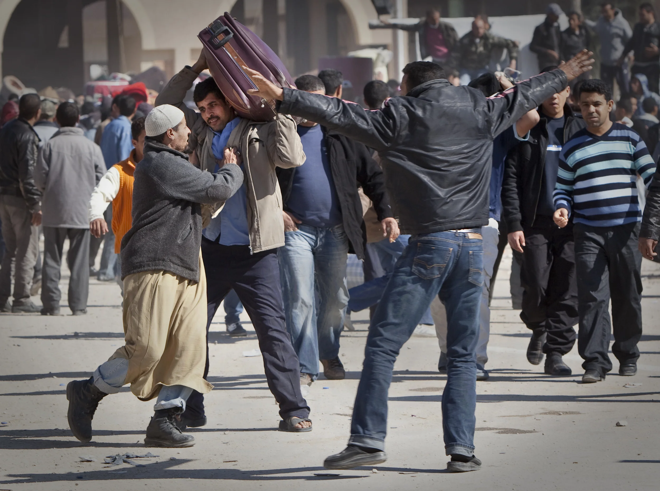  Tunisian men from a town close to the Ras Jdir border crossing with Libya try to prevent Egyptian refugees from entering Tunisia as they were concerned about the numbers fleeing. &nbsp;March 2011.    