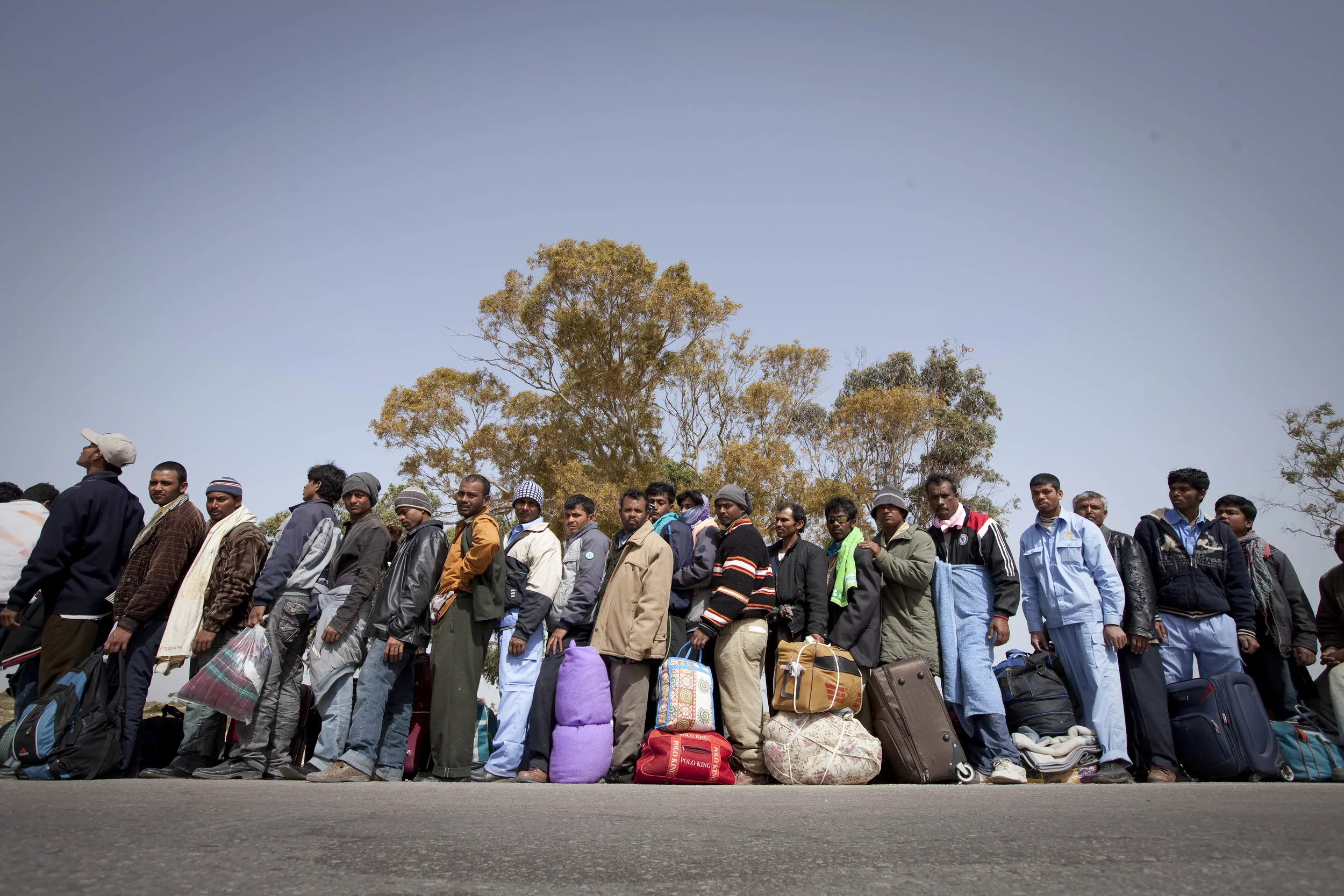  Some of the thousands of Bangladeshis awaiting access to a transit camp in Tunisia after fleeing a worsening situation in Libya as the rebellion against Gaddafi takes hold. &nbsp;March 2011. 