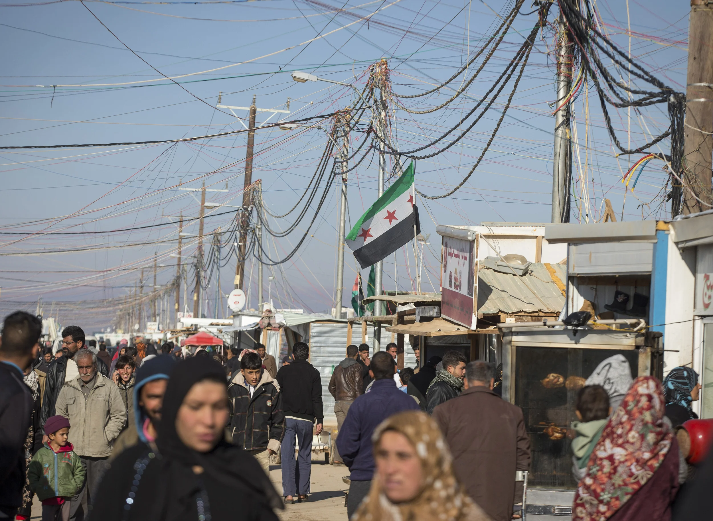 A Syrian rebel flag flies above a busy thoroughfare at the Za'atari refugee camp for Syrians, in norther Jordan. December 2013.