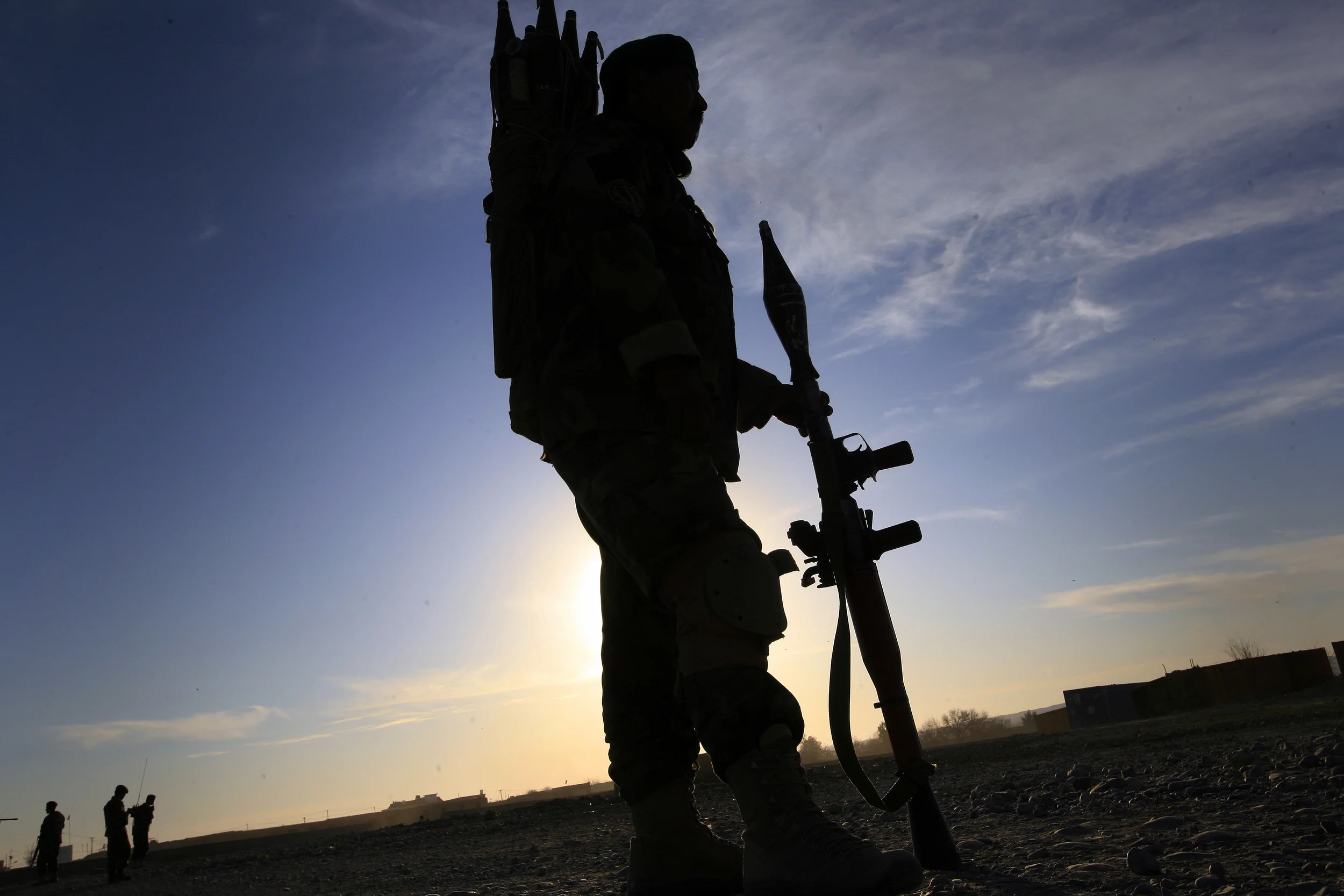 A soldier of the Afghan National Army, 'stands to' at dusk during a patrol with 3 Rifles, Sangin, Afghanistan, 2010.
