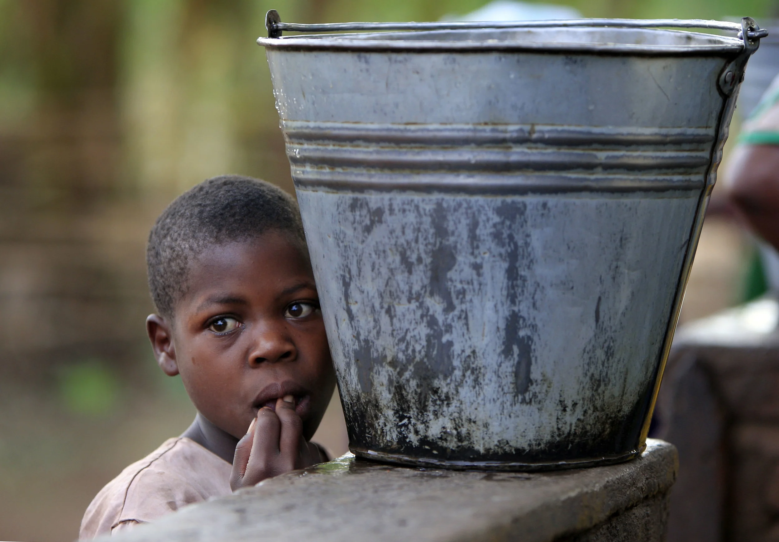  A young child in the village of Mwachilolo at a 'Pump Aid' Elephant pump. November 2008. 
