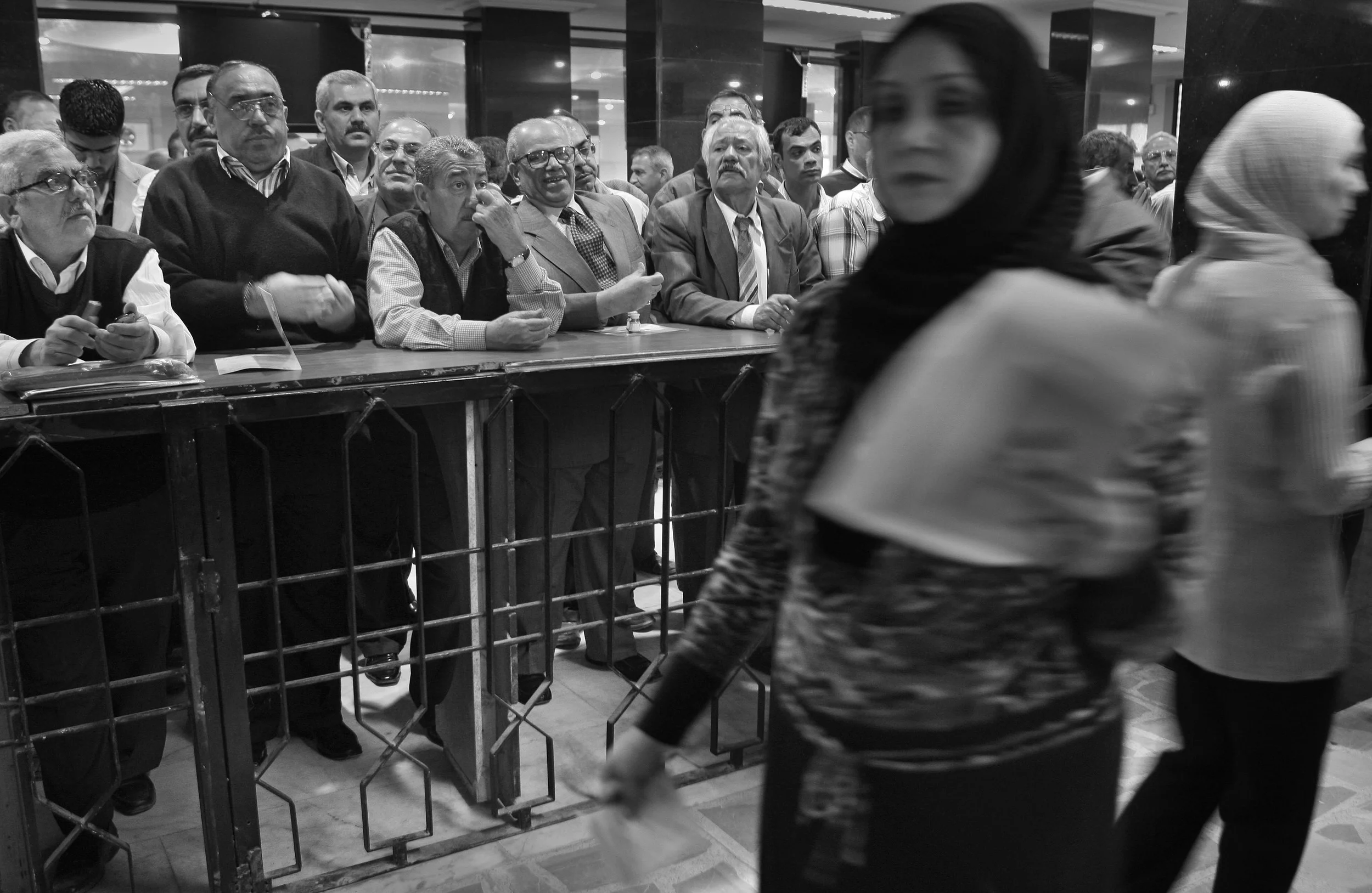 Investors at the Iraqi stock exchange in Baghdad monitor the main trading boards, during a morning trading session. March, 2009.
