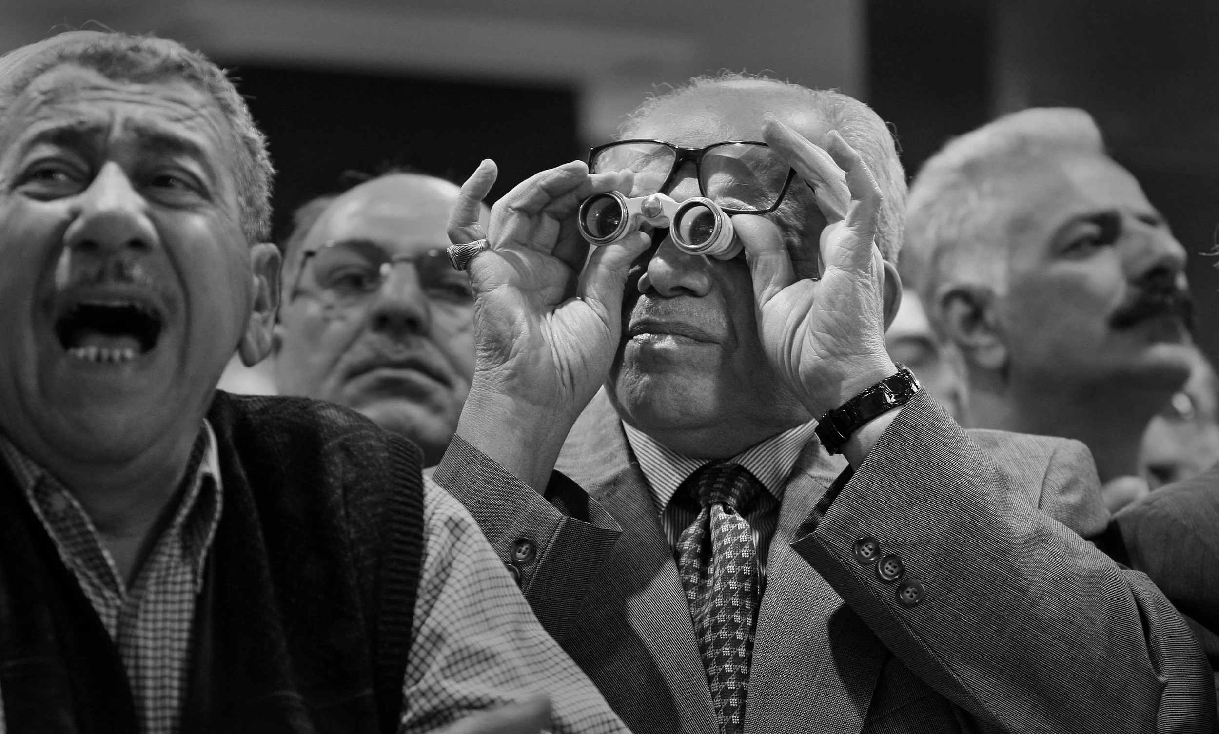 Investors at the Iraqi stock exchange in Baghdad watching the trading boards and trying to attract the attention of brokers during a morning session. March, 2009.
