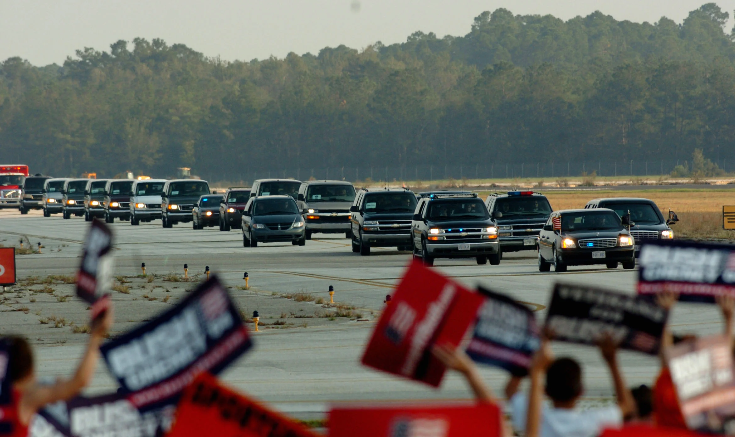  President George W Bush in his cavalcade as it drives across a runway at Gainsville, N. Florida to attend a rally there. October, 2004. 