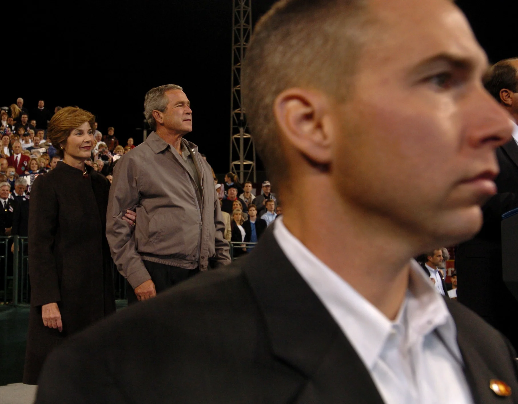  President George W Bush with wife Laura stand as the 'Stars and Stripes' is played during a rally in Cincinatti, Ohio, in the run-up to the U.S. presidential election. November, 2004. 