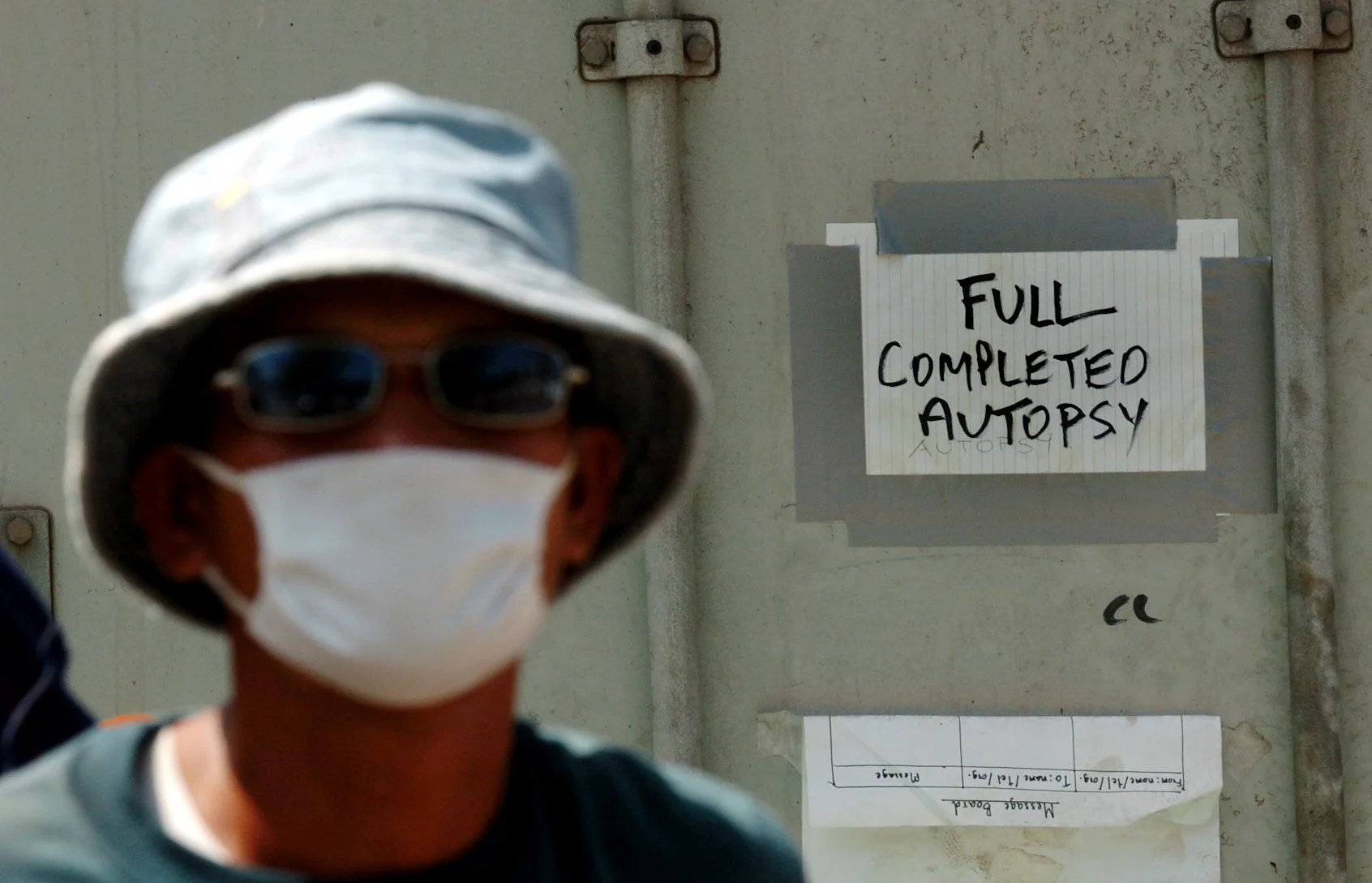  A Thai worker next to a container storing bodies that were collected after the Asian tsunami, Christmas 2004. Khao Lak, Thailand, January 2005. 