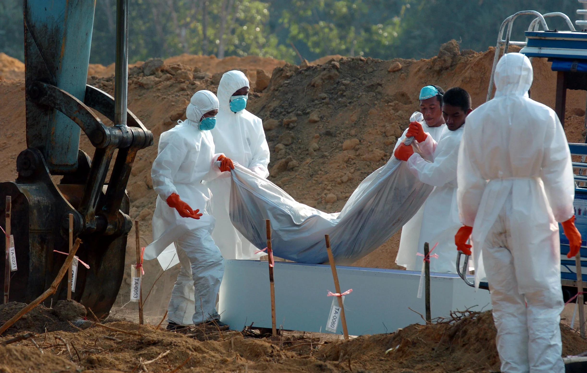  Thai officials bury some of the thousands of unidentified bodies in mass graves near Khao Lak, Thailand in January 2005, following the tsunami which struck, christmas, 2004. 