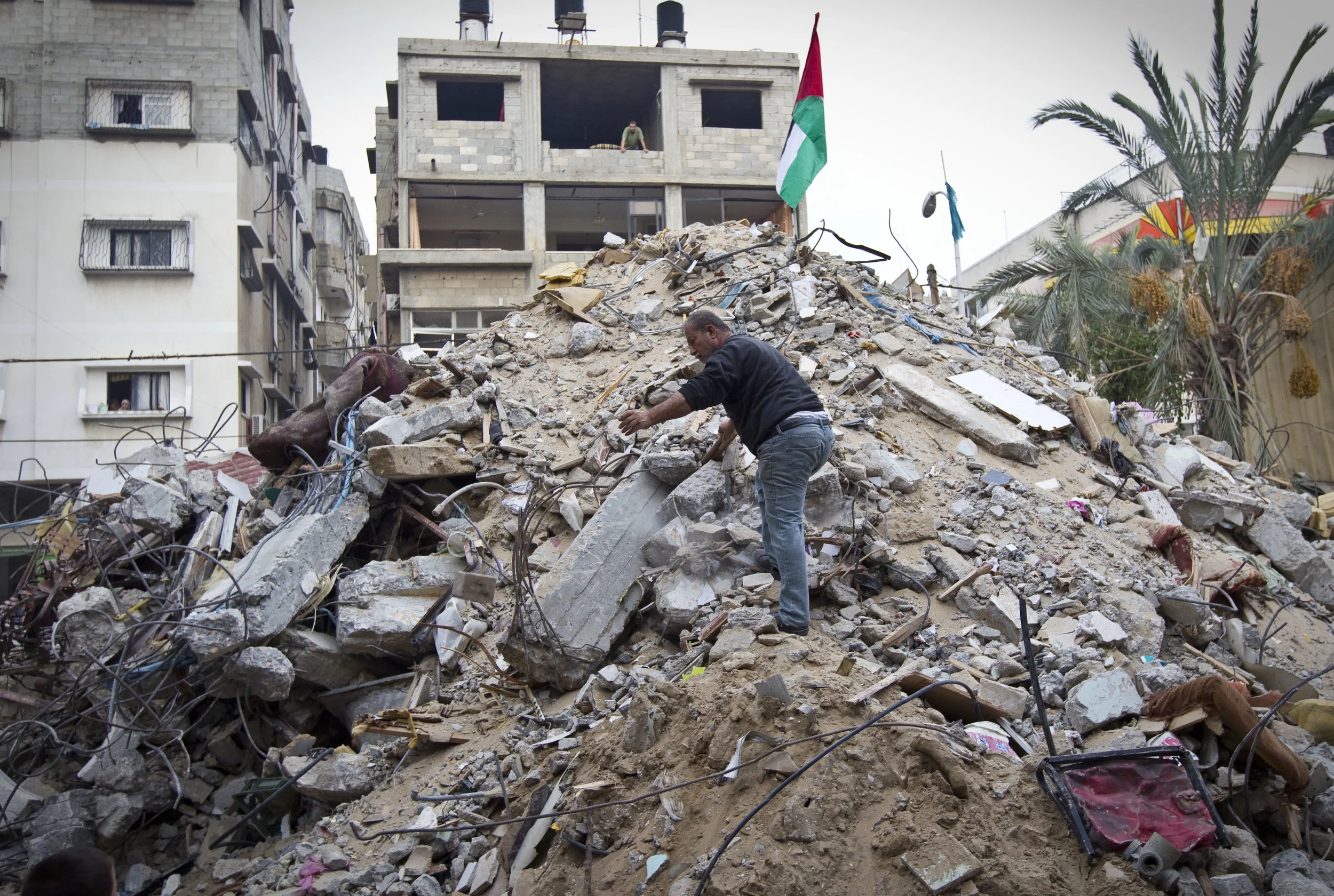  A man digs onto the rubble of a destroyed house in which twelve members of one family were killed following a strike from an Israeli missile. &nbsp;December 2012. 