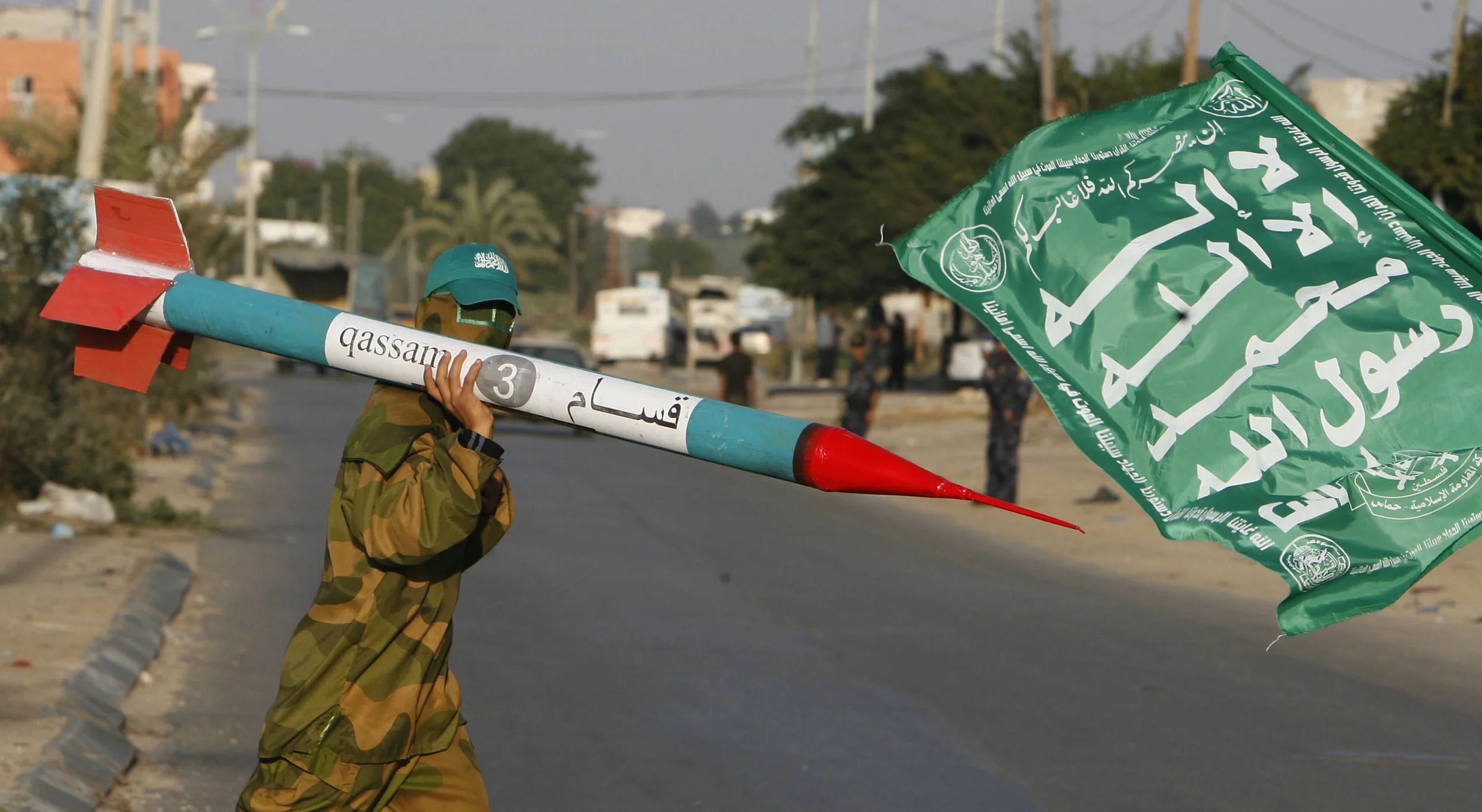  A HAMAS member carries a model of a Qassam rocket, during 19th anniversay celebrations of the Gaza based organisation. Gaza, December 2006. 
