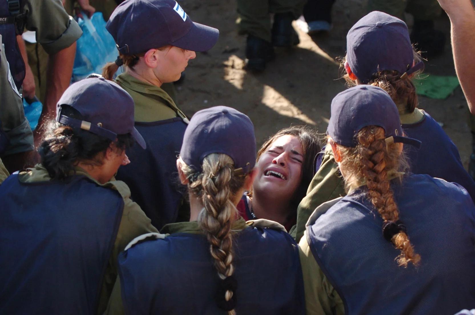  A young woman is carried away from the Newe Dekalim synagogue, by Israeli police during the disengagement from Gaza. August 2005. 