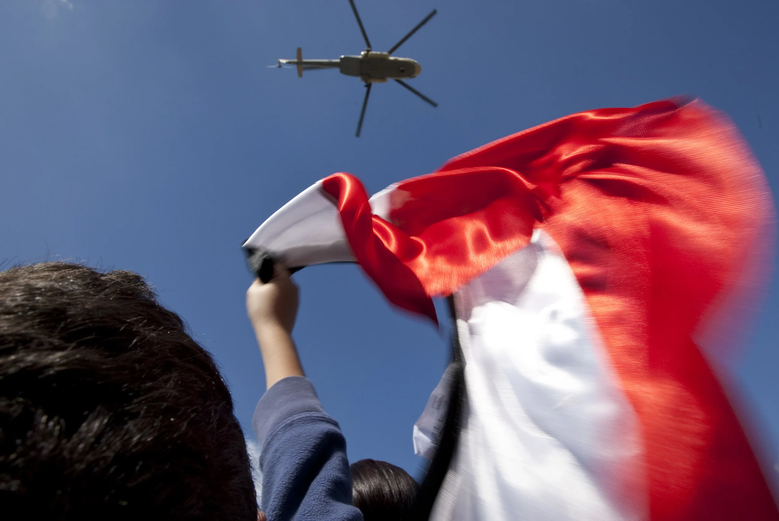  An anti Mubarak protester jeers at a government helicopter making a pass over Tahrir square, Cairo, 2011 
