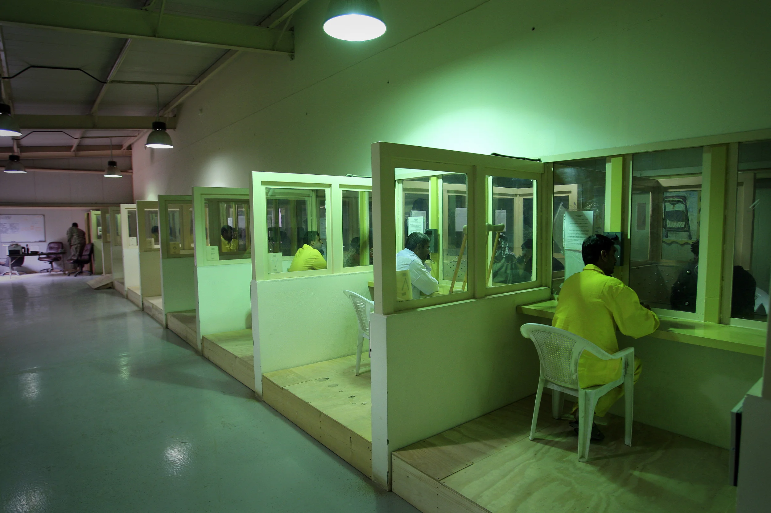 Iraqi detainees at the U.S. run prison, Camp Cropper, are allowed family visits and may have private conversations through toughened glass and via a telephone. (Identities concealed as they are suspects only at this point, not convicts). Baghdad, April 2009.