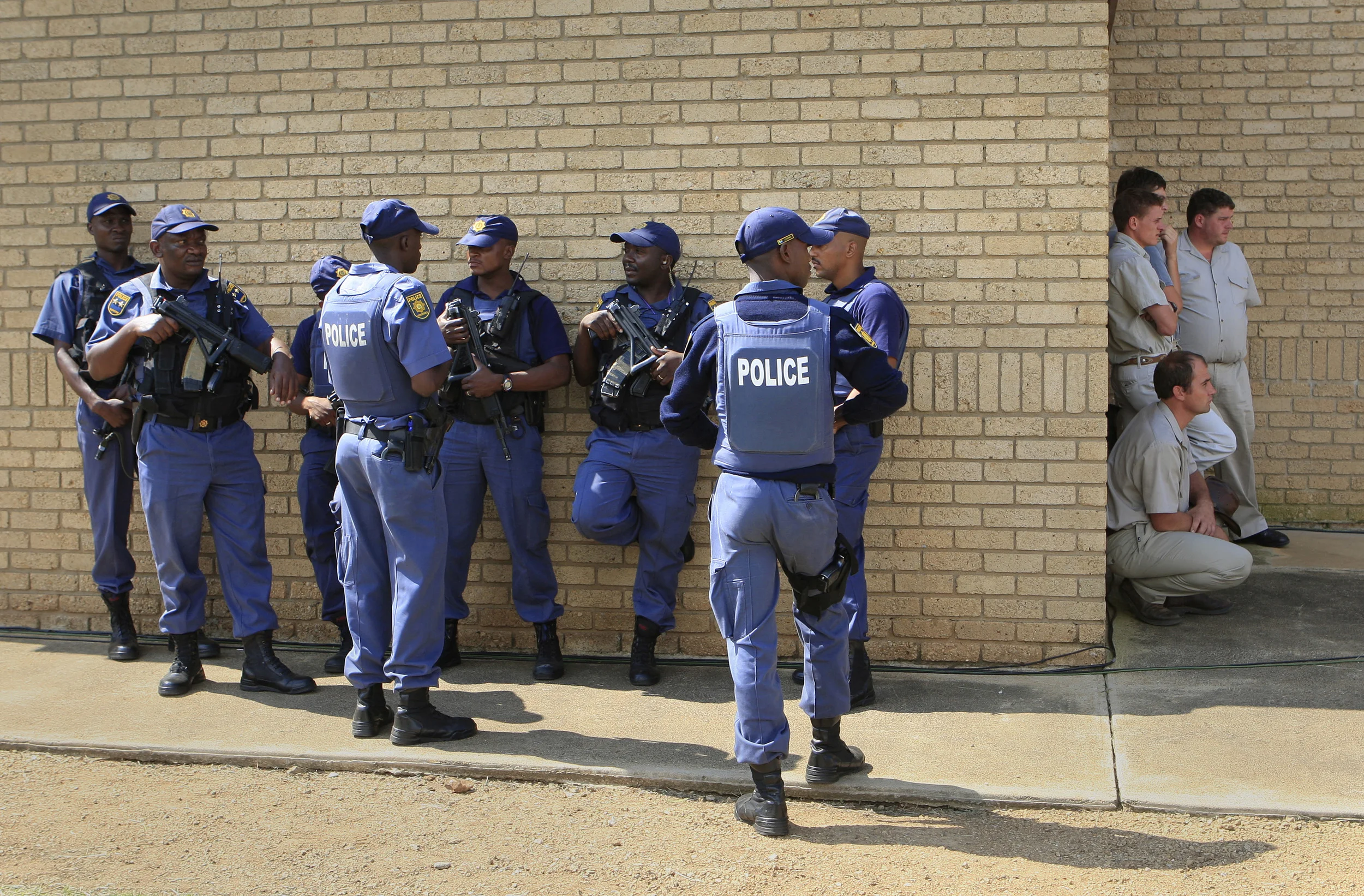 Police on duty next to mourners of the murdered AWB founder, Eugene Terre Blanche, at his funeral in Ventersdorp, South Africa. April 2010.