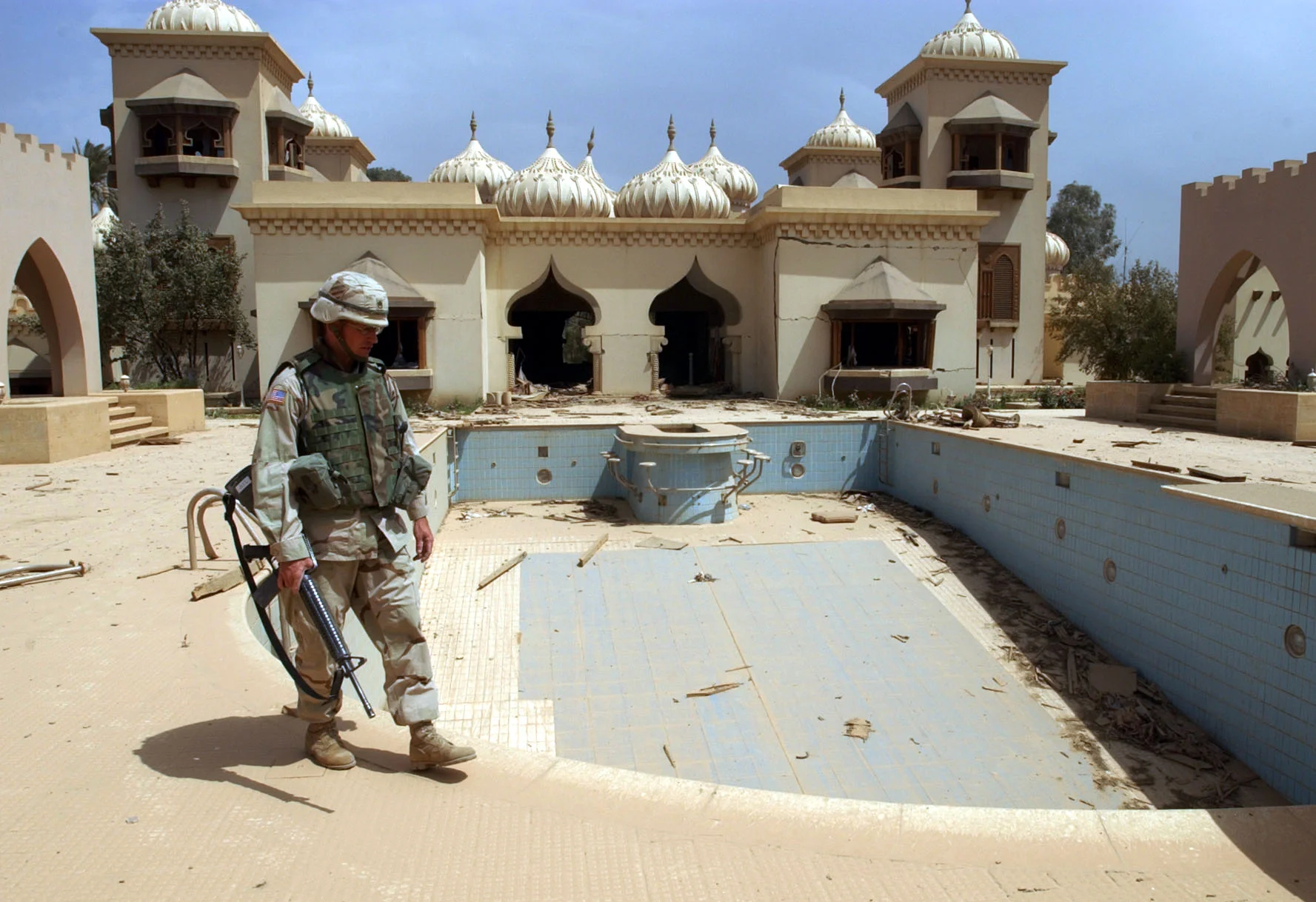   A U.S. soldier enters one of the many 'luxury' villas in Saddam Hussein's palace complex on the banks of the river Tigris in Baghdad, a day after the American's 'liberated' the city. April 2003. 