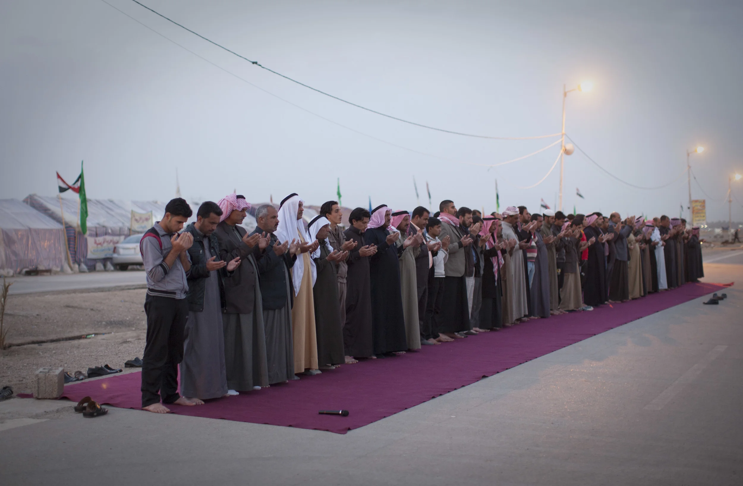  Anti government protesters at a camp in Anbar province, Iraq, pray at dusk, as they continue their ten week protest their against Prime Minister, Nouri al-Maliki. &nbsp;Ramadi, Iraq, March 2013. 