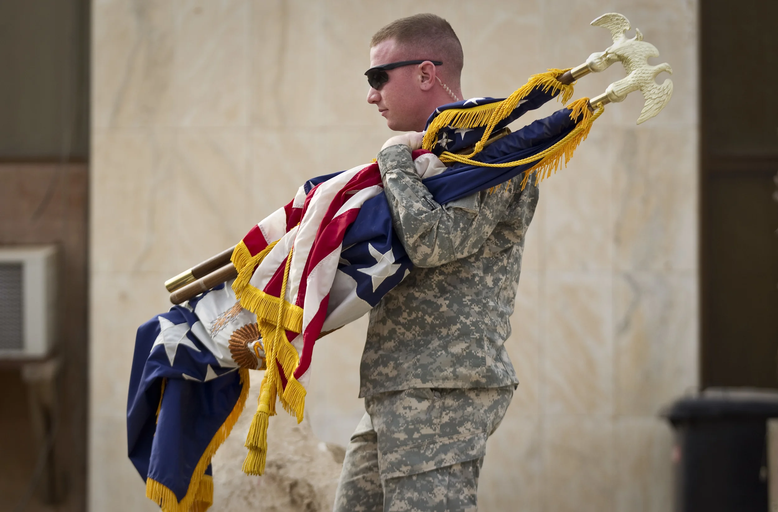  A US soldier removes flags for the last time following the ceremony marking the Americans end of mission in Iraq. &nbsp;Baghdad airport, December 2011. 