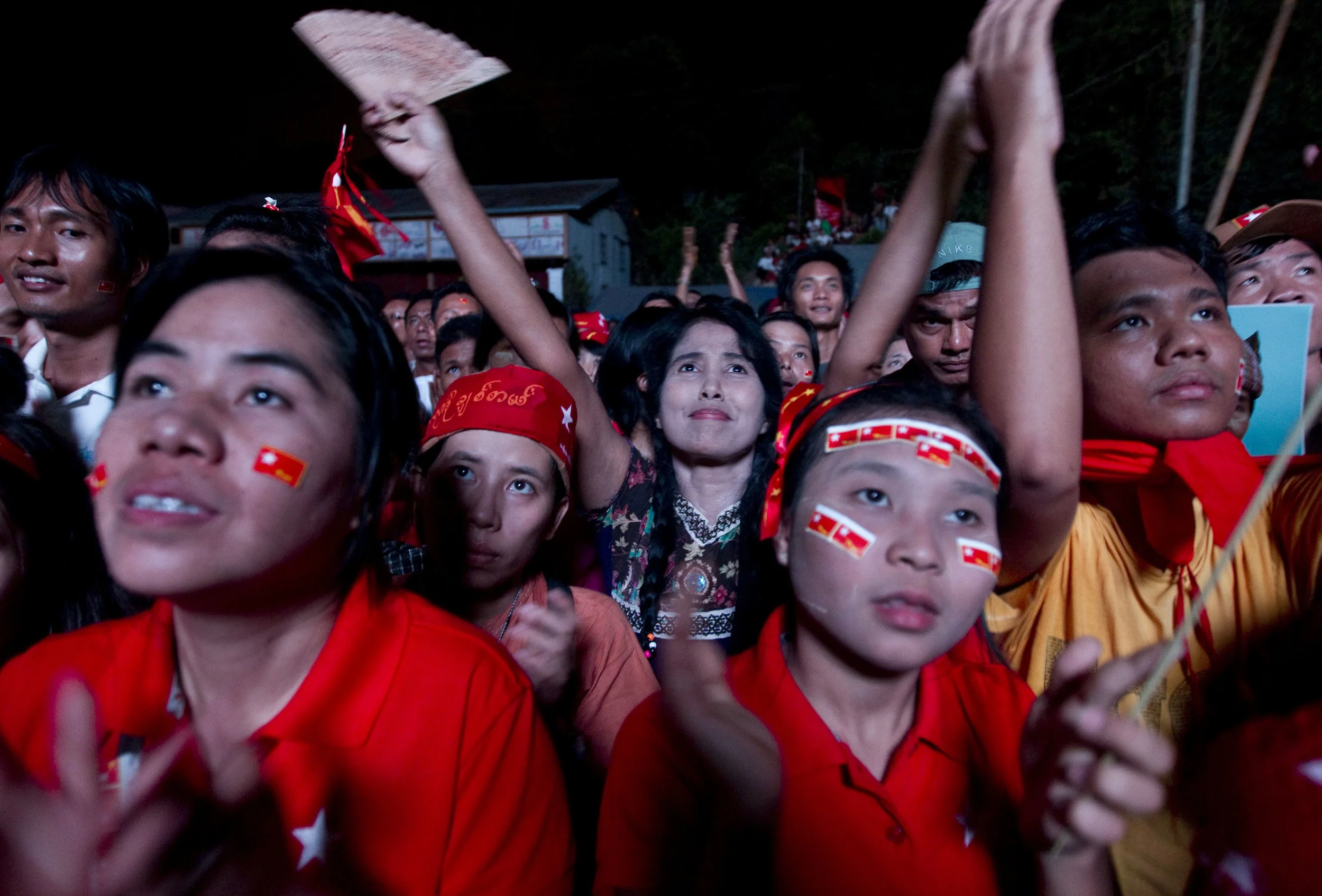  NLD supporters celebrate as they being returned on a screen at the party's headquarters in Rangoon following Burma's parliamentary elections, in which Aung San Suu Kyi won a seat. April 2012. 
