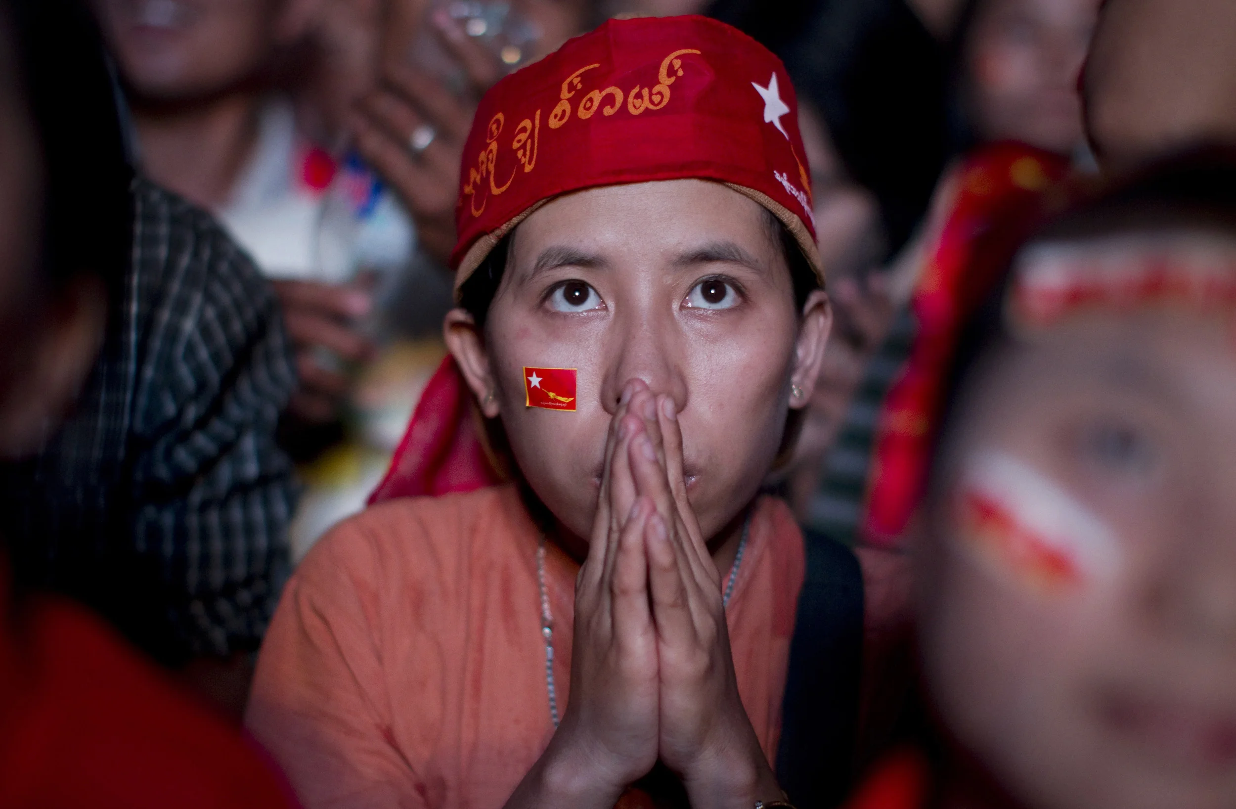  NLD watch a monitor anxiously at the party's headquarters in Rangoon as election results are returned, including that of Aung San Suu Kyi. April 2012. 