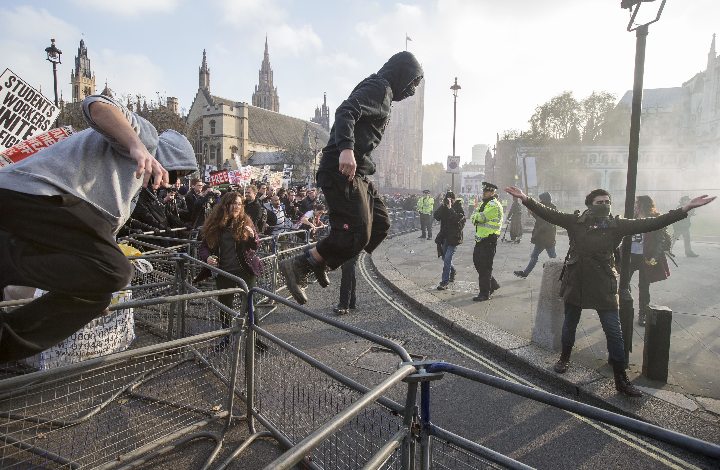 Students breach barriers in front of the Houses of Parliament, London, during a protest over student funding. November 2014