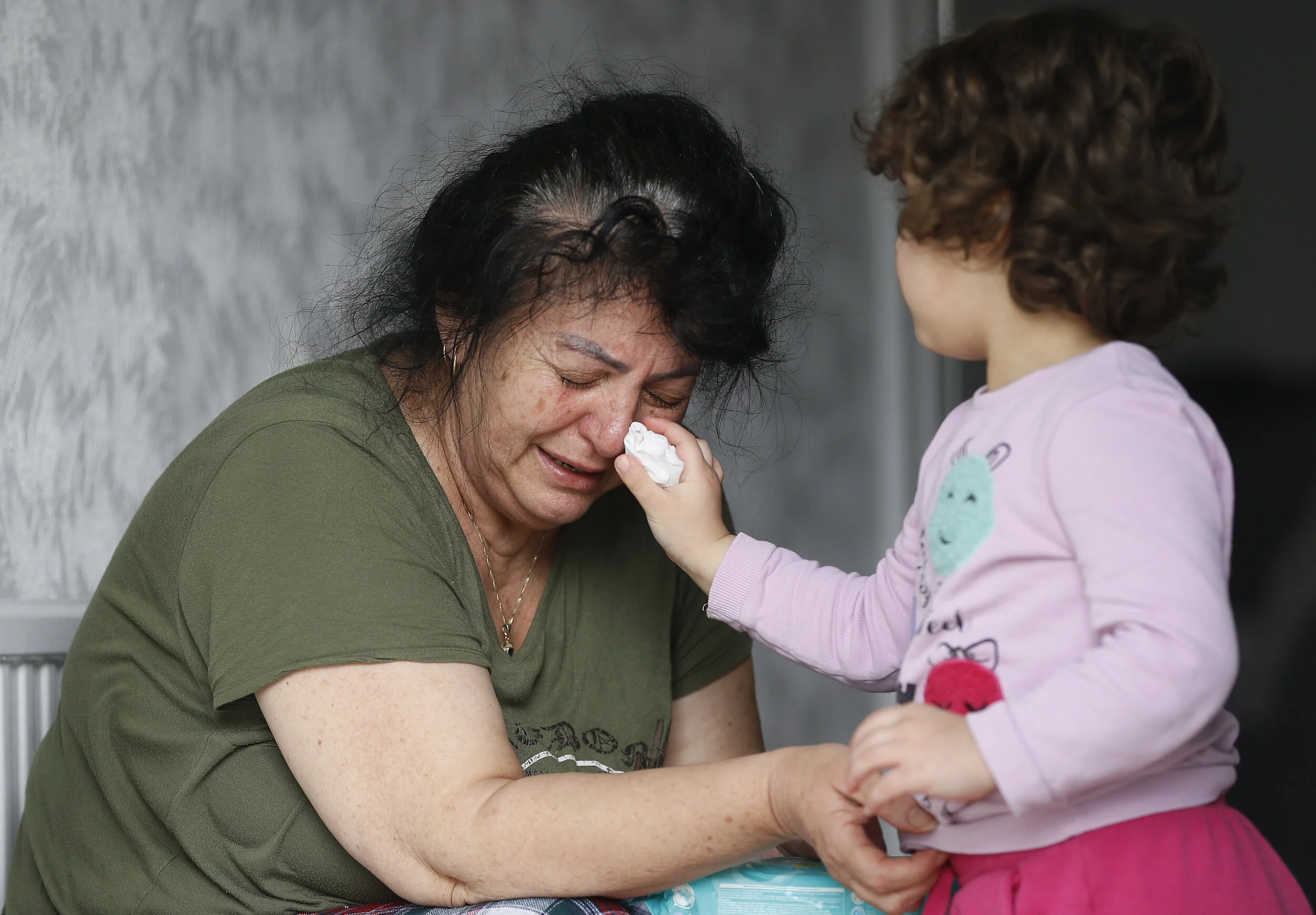  Ayse Mehmet has tears wiped by her 3 year old granddaughter Ayse at her home, as the spread of the coronavirus disease (COVID-19) continues, in Enfield, Britain, April 27, 2020 
