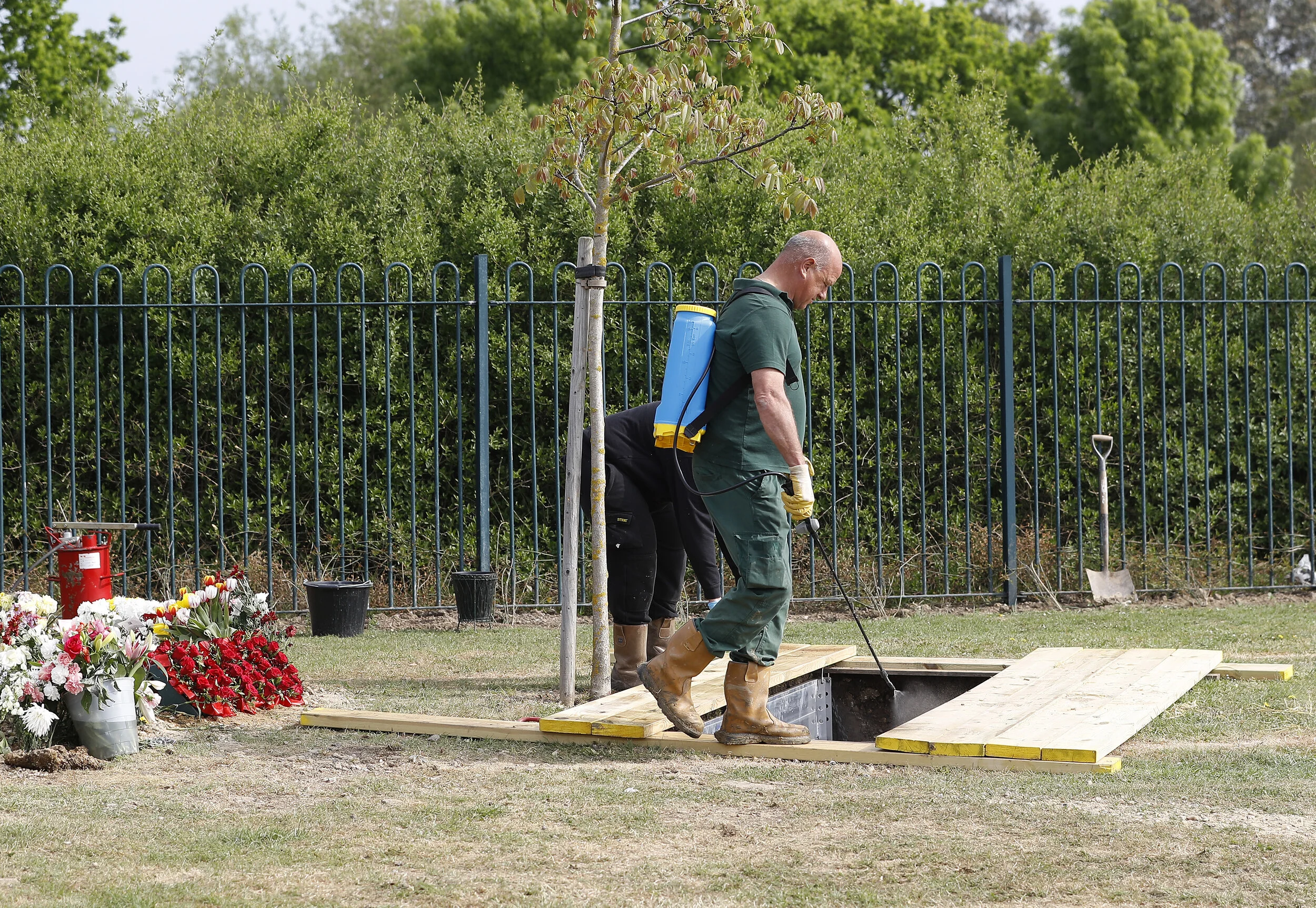  A cemetery worker disinfects the grave at the funeral of COVID-19 victim Ozcan Aygin takes place at Chadwell Heath cemetery as the spread of the coronavirus disease (COVID-19) continues, in Romford, Britain, April 27, 2020 