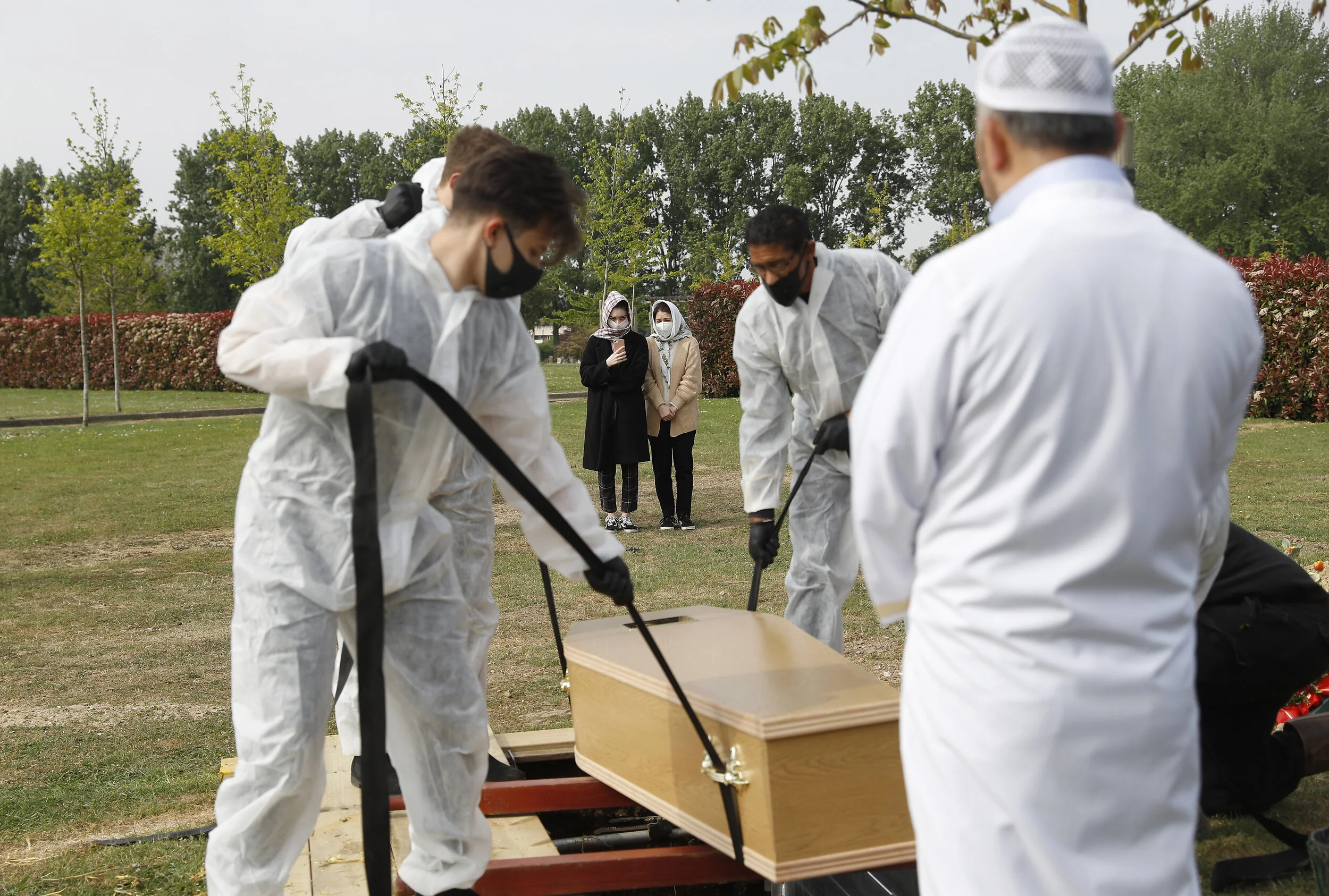  The daughter and granddaughter of COVID-19 victim Ozcan Aygin look on at his at Chadwell Heath cemetery as the spread of the coronavirus disease (COVID-19) continues, in Romford, Britain, April 27, 2020 