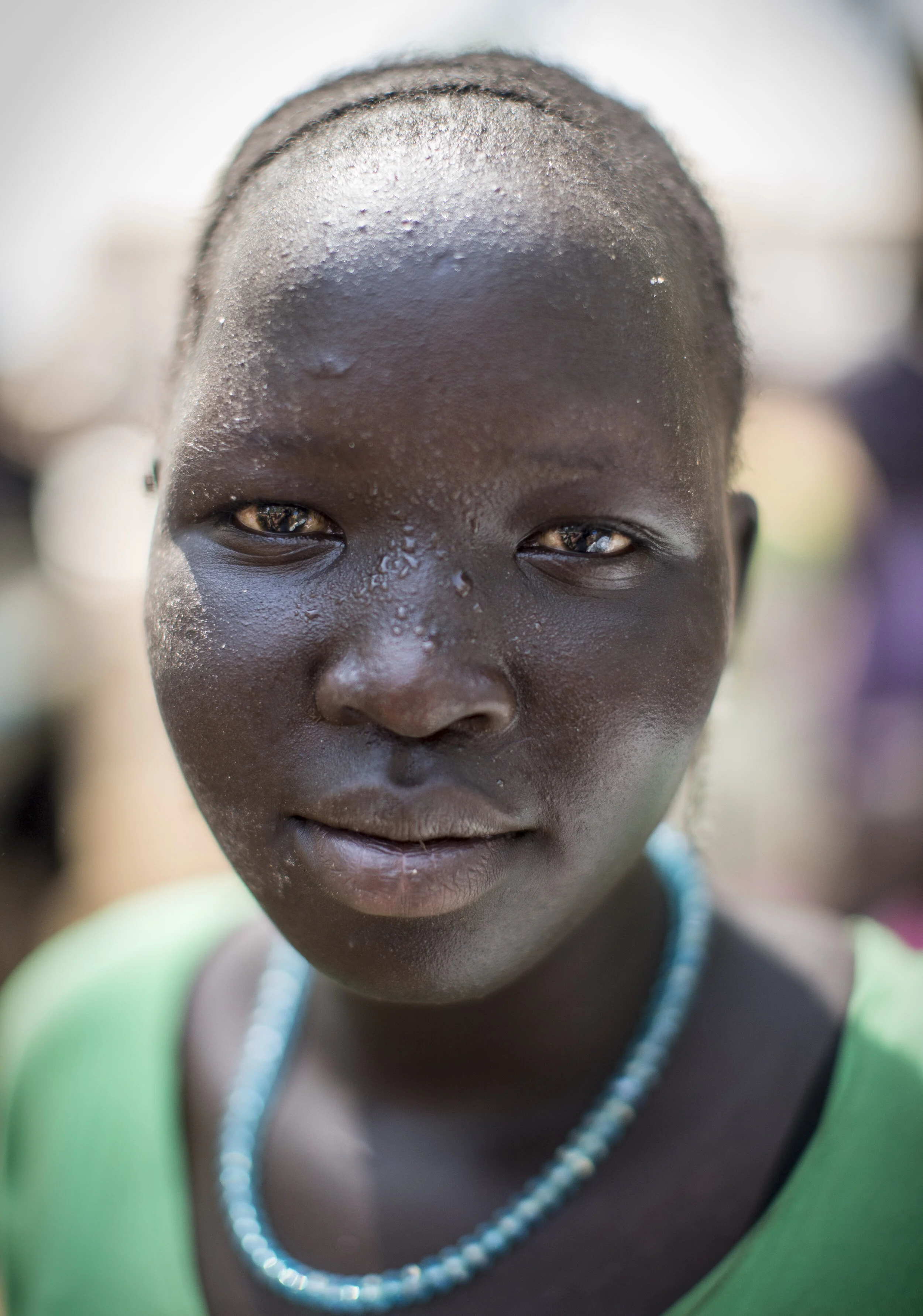  South Sudanese refugee, Nyaroud Gack Tong, from Nasir, poses for a portrait while waiting for her food aid allocation at the Kule refugee camp, in Ethiopia. November 7, 2014 