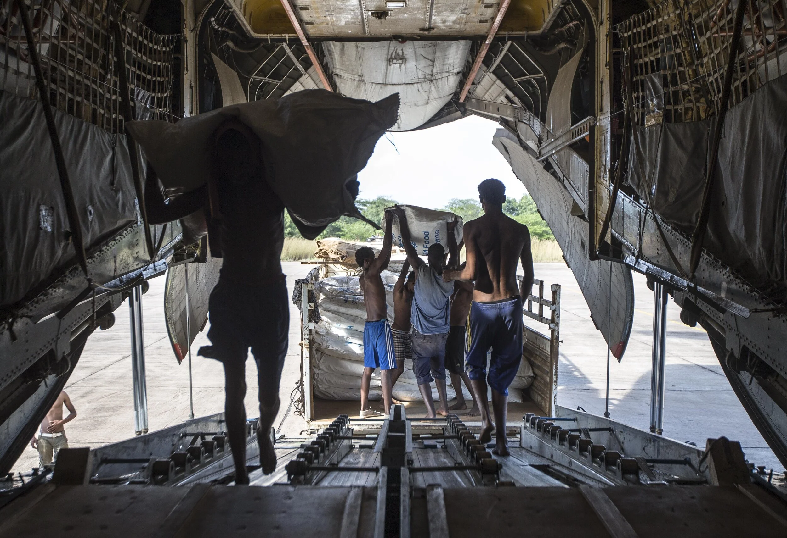  Workers load bags of WFP maize meal onto a transporter aircraft at Gambella, Ethiopia, for air drops into South Sudan, for people displaced by the worsening internal conflict there. November 7, 2014 