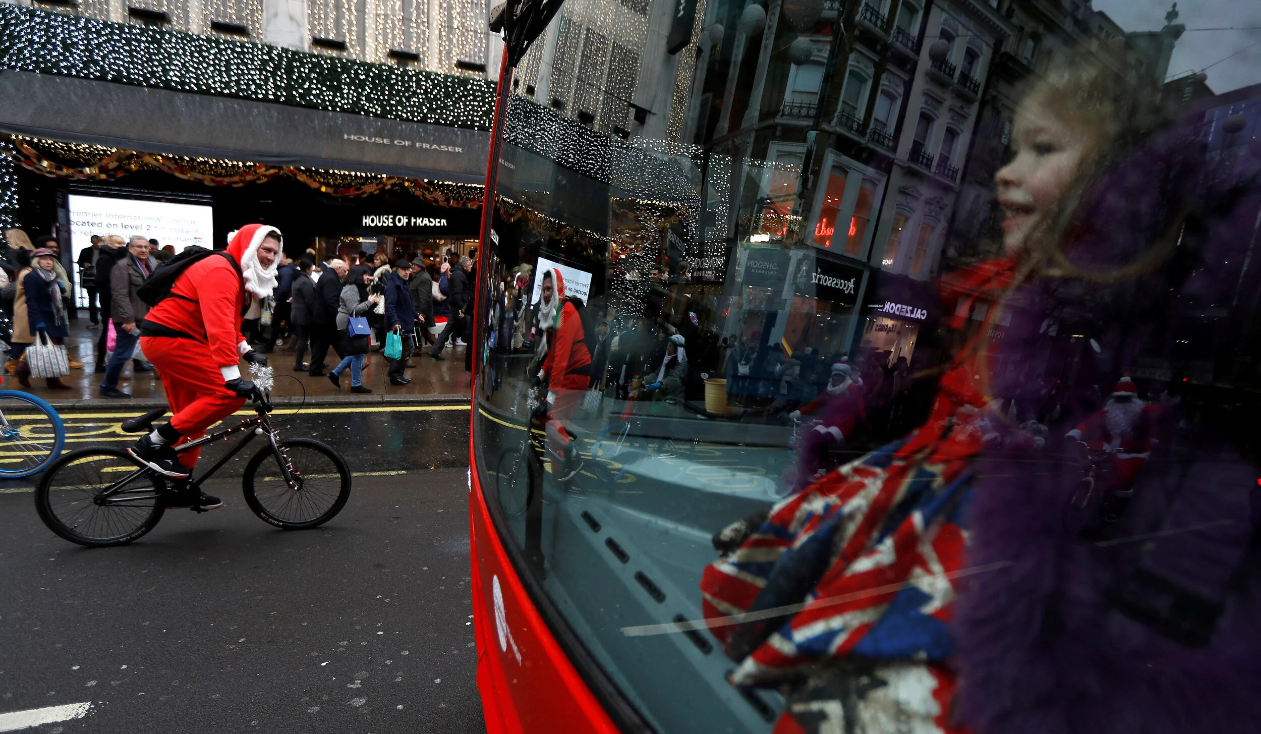  Santa's on BMX cycles take part in a charity ride along Oxford street in London, Britain December 16, 2017.  