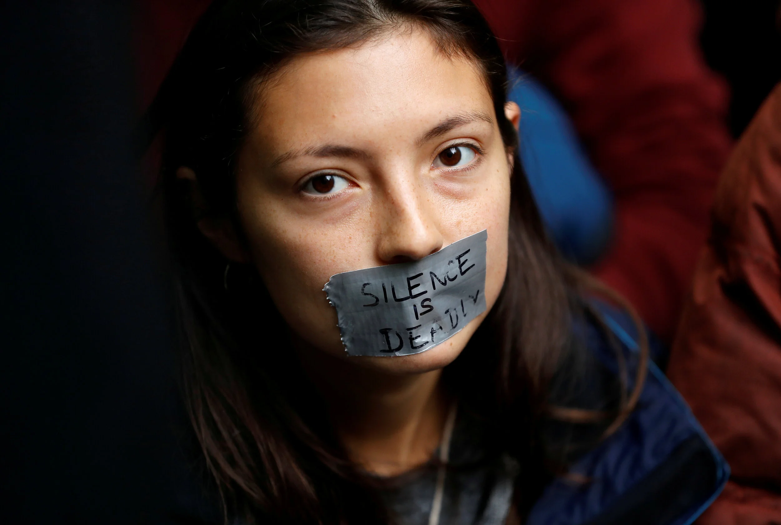  A protester with her mouth taped is pictured outside the BBC Headquarters during an Extinction Rebellion demonstration in London, Britain October 11, 2019.  