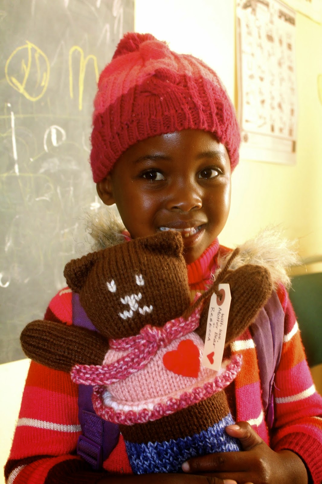 The Mother Bear Project is run out of Minnesota. They send teddy bears to kids, so that they can have a toy that is completely their own and to provide emotional comfort. I gave them out to the kindergarteners at the elementary school, and this girl had particularly pretty smile.