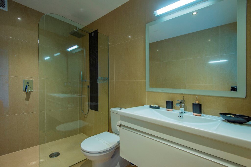 Modern tiled bathroom with overhead rain shower