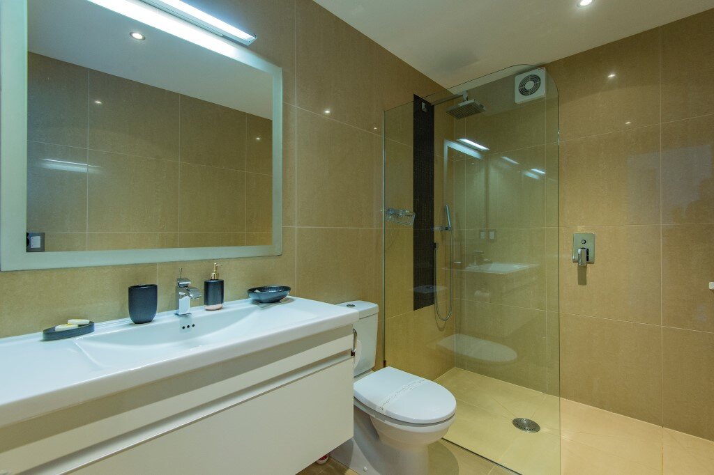 Modern tiled bathroom with overhead rain shower