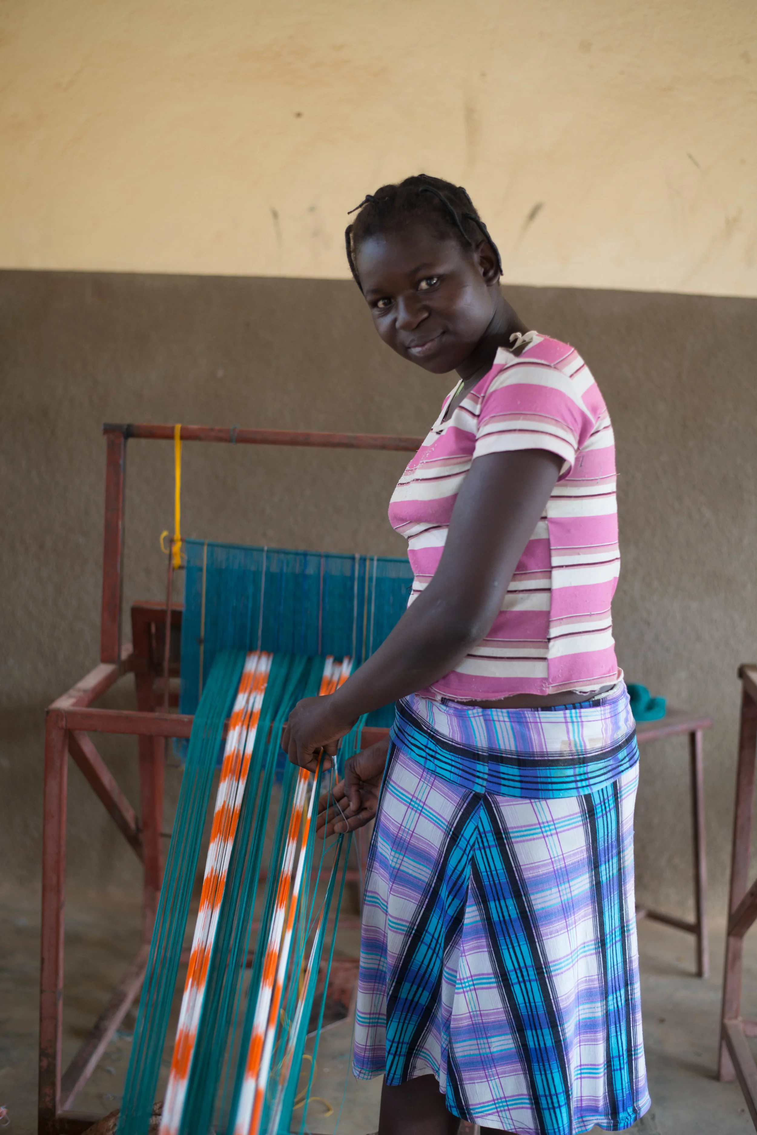 Germane untangling her loom.