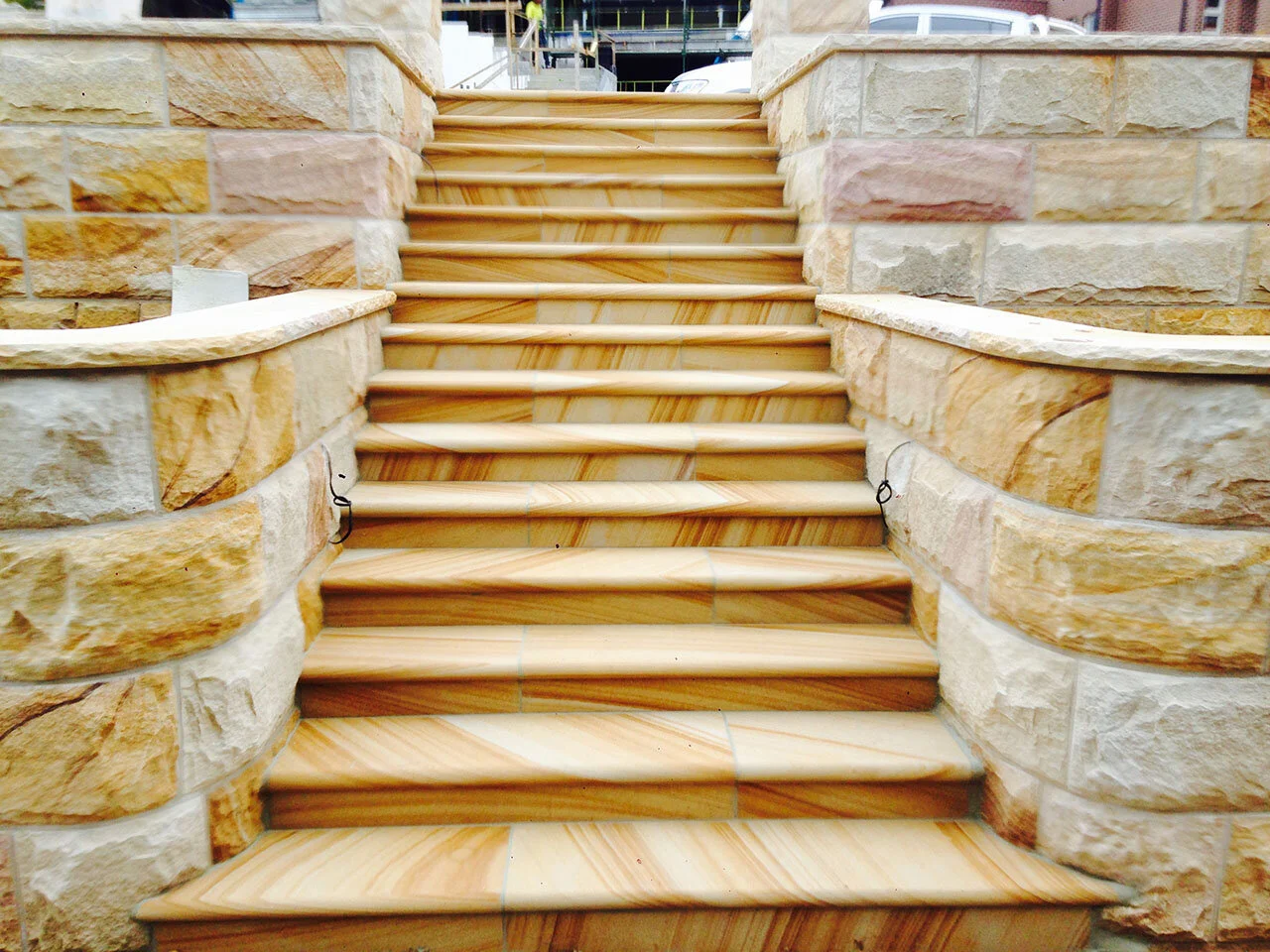 Curved rock faced walling, bullnose steps, brown sandstone colour range