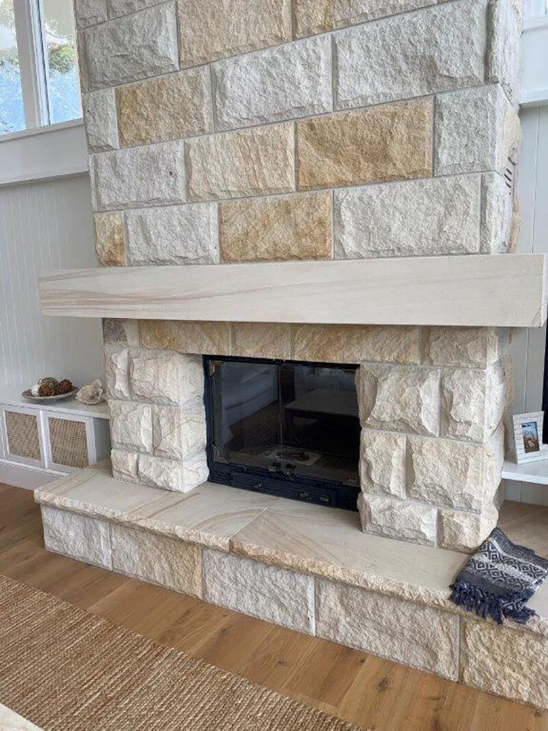 White-light brown Select rock faced sandstone cladding, with sawn fireplace mantle