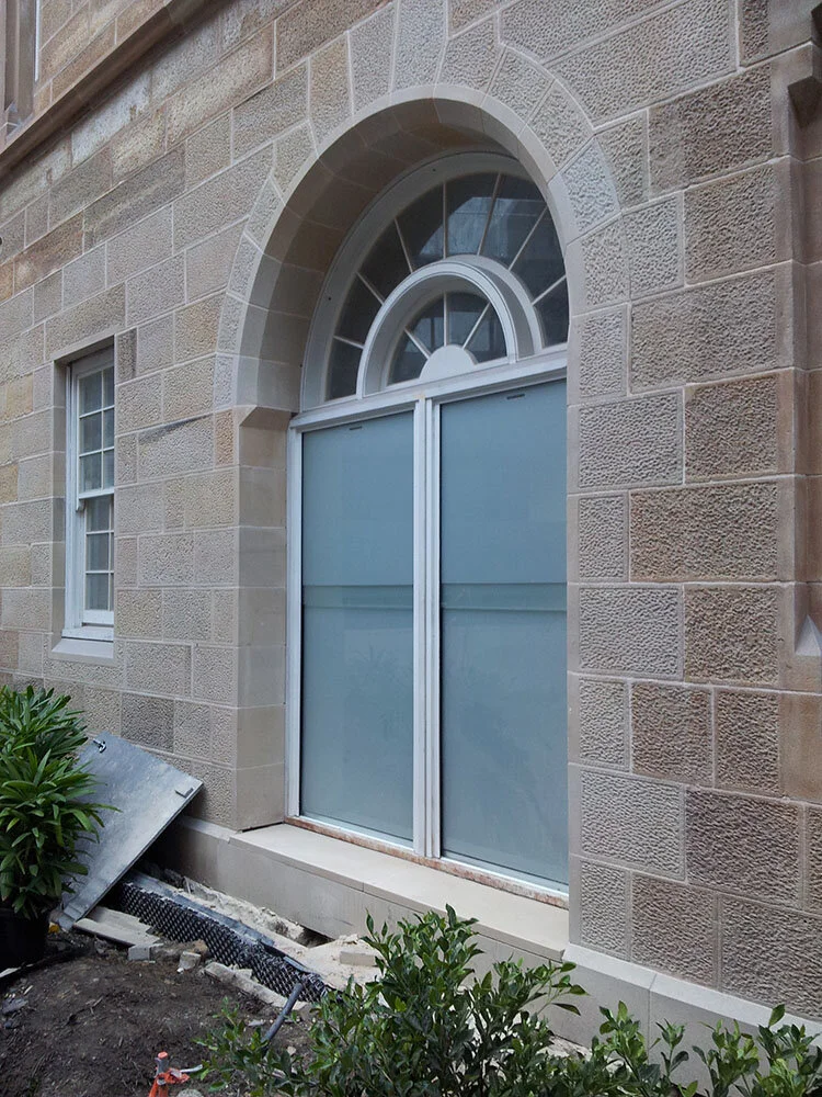 Buff colour range - sandstone restoration project; sparrow pecked sandstone walling with sawn margin