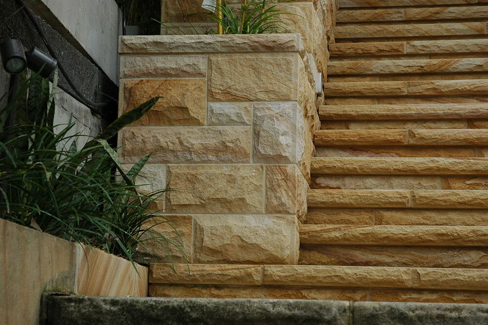Gosford Quarries medium brown random square rock faced walling with sawn margin and sandstone steps