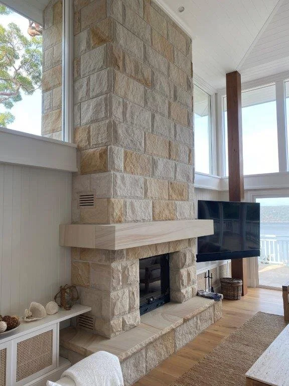 Classic rock faced fireplace with sawn mantel by Gosford Quarries.