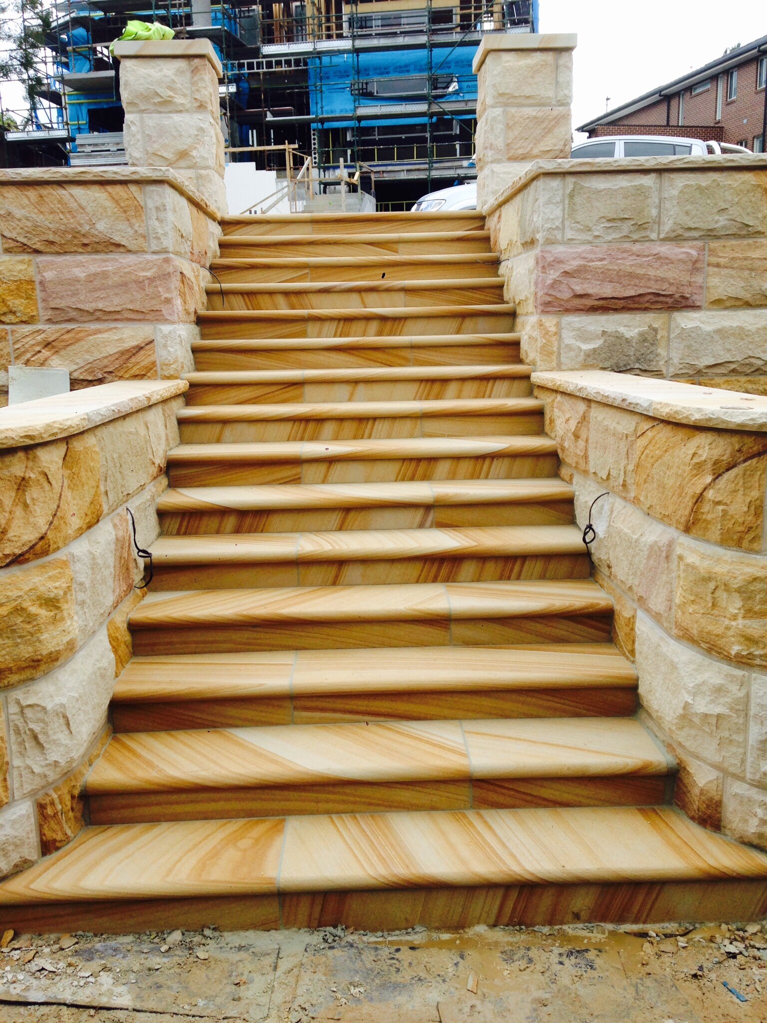 gosford-quarries-sandstone-supplies-sydney-melbourne-brisbane-Elite Stonemasons-Kellyville-project-medium-brown-bullnosed-steps-with-brown-range-curved-rockfaced-walling.jpg