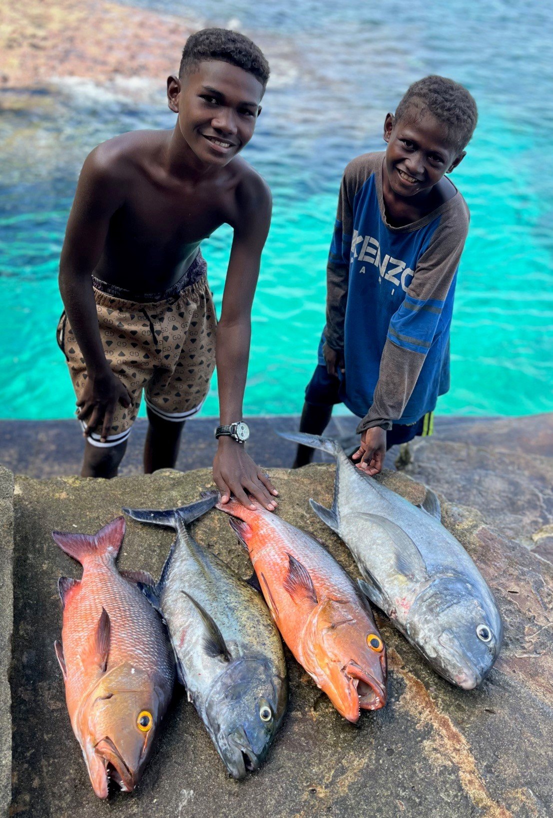 Solomon Kids with Fish Zoleilo Bungalows.jpg