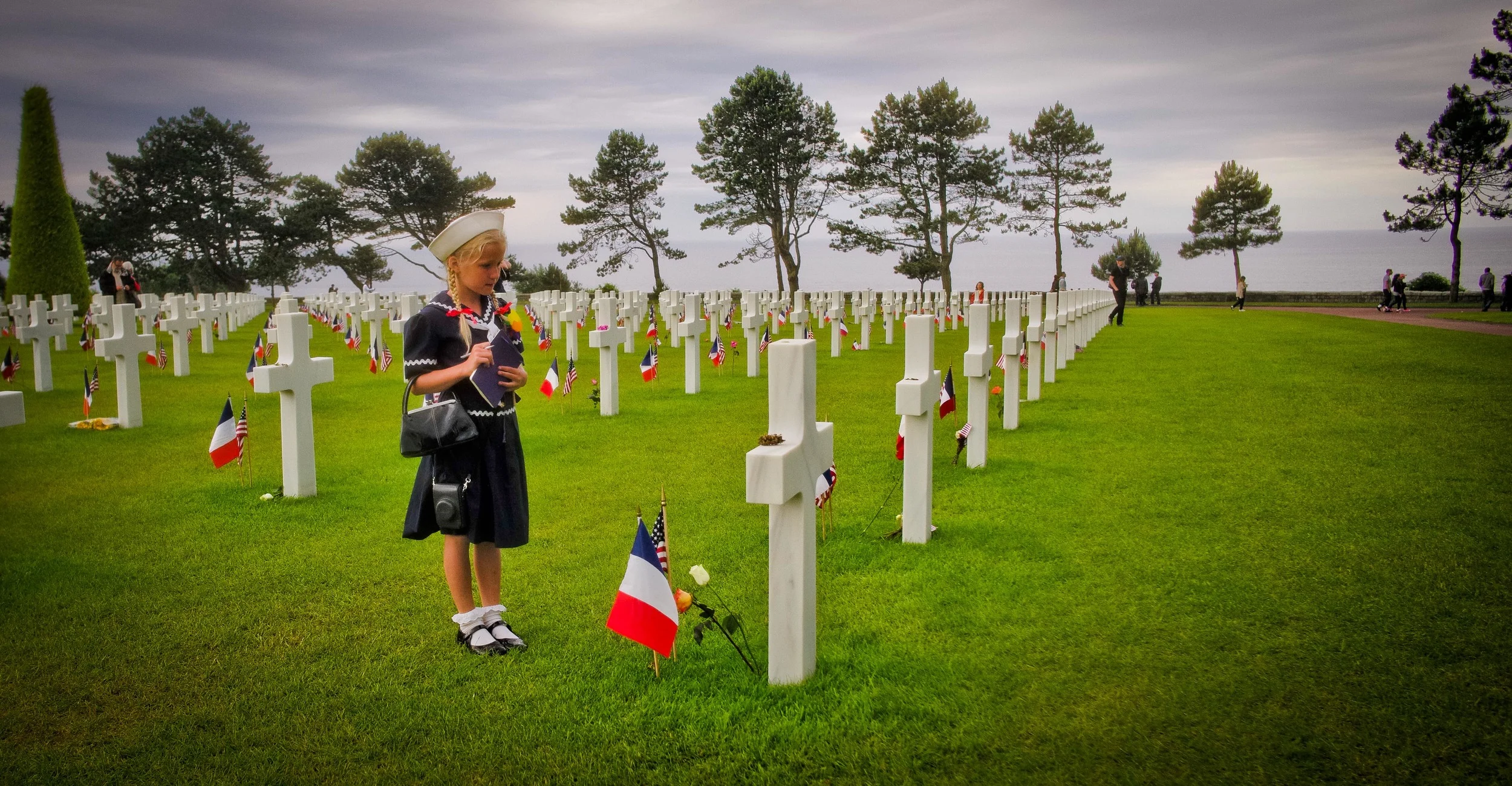 Virginia writes down the names of our fallen heroes at Omaha Beach Cemetery. 