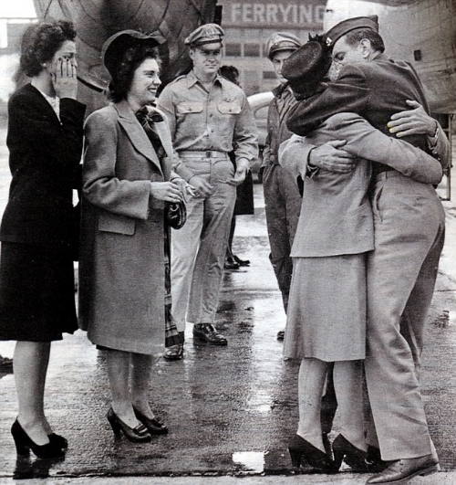 Louie, reunited with his family after years of separation, is warmly embraced by his loving mother and father. 