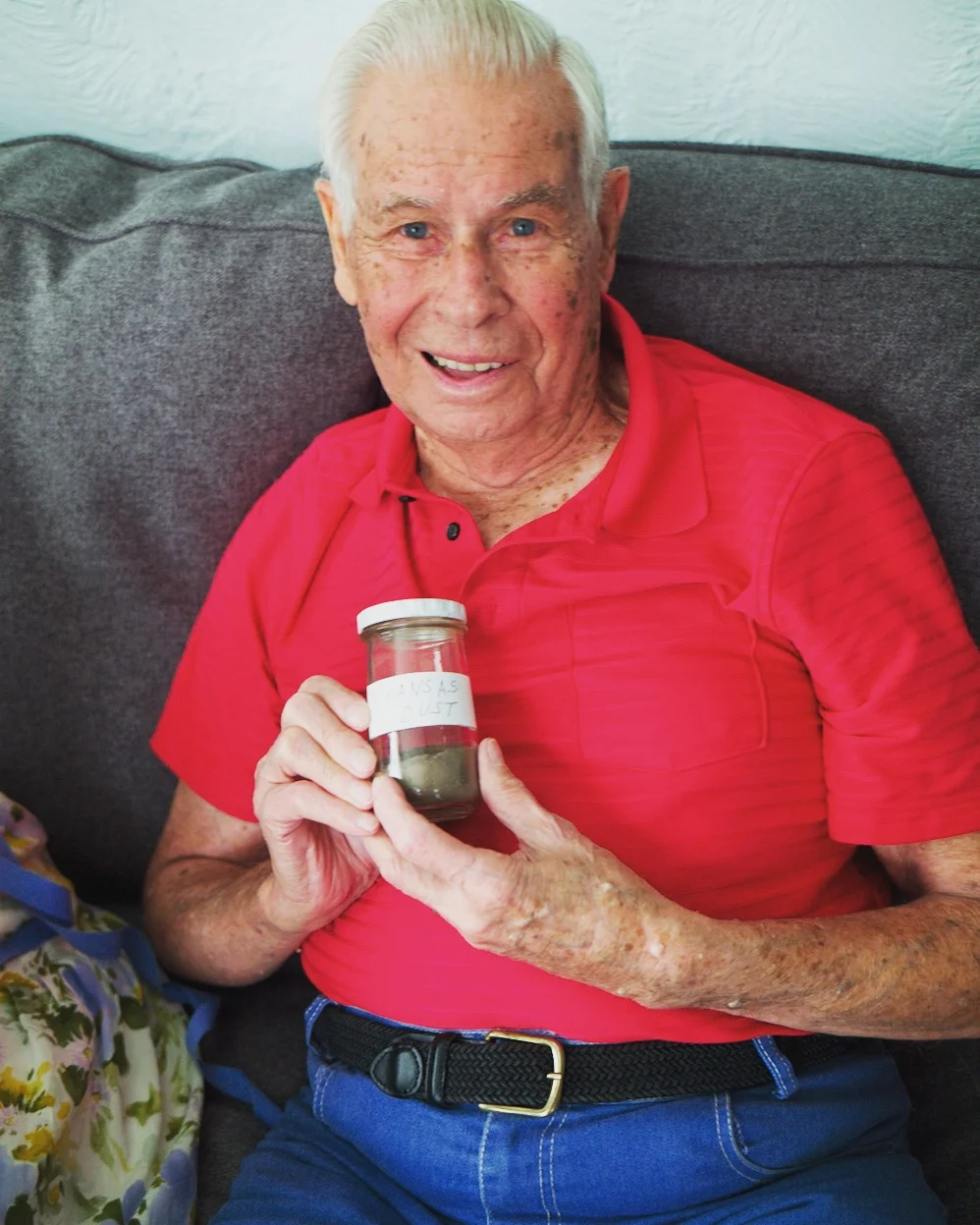 Holding a bottle of dirt from the "Dust Bowl."
