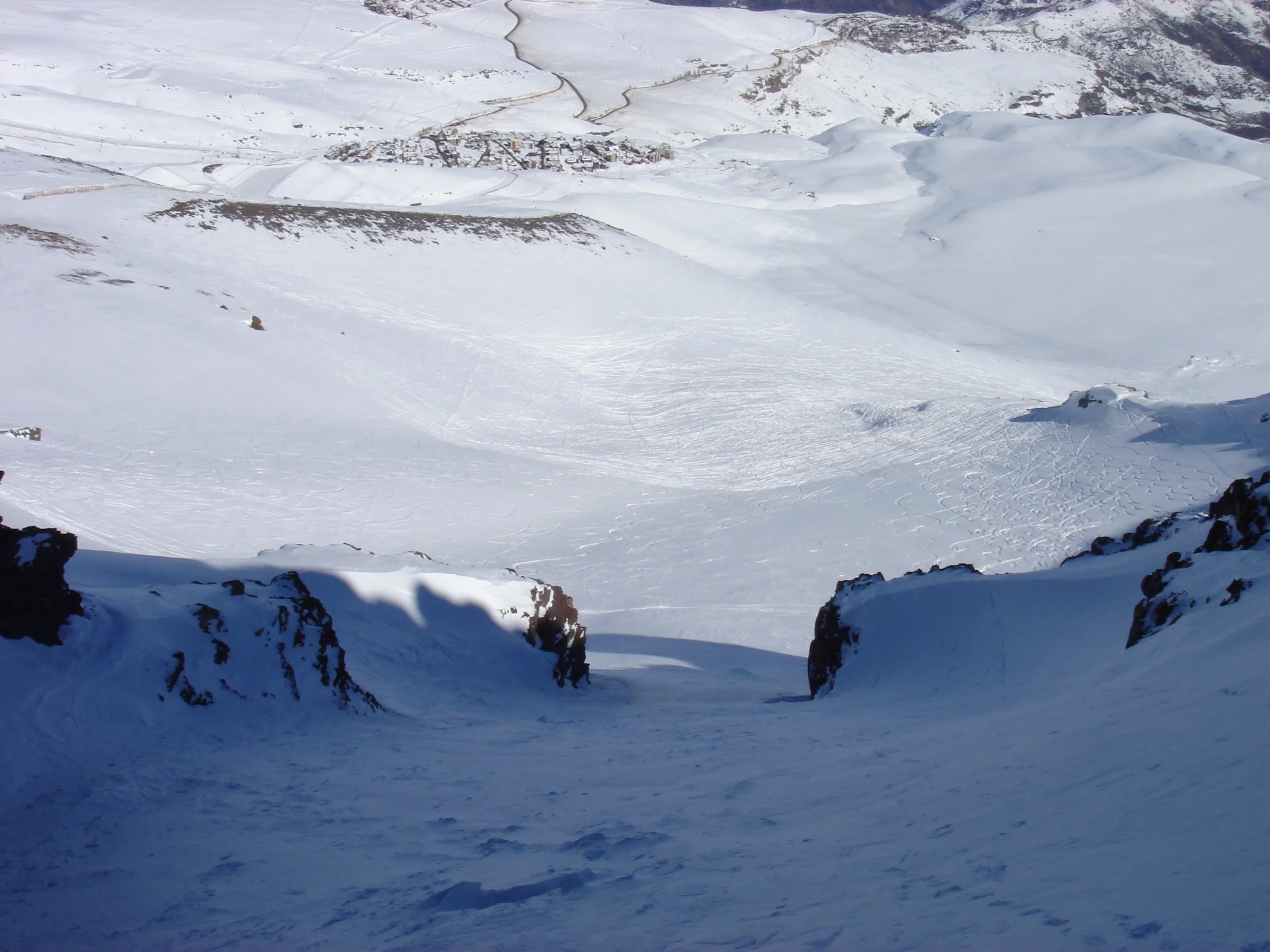 First tracks await down the hike-to couloir, La Chimenea, just beyond the highest lift at La Parva. Seen below are the villages of La Parva and Farallones