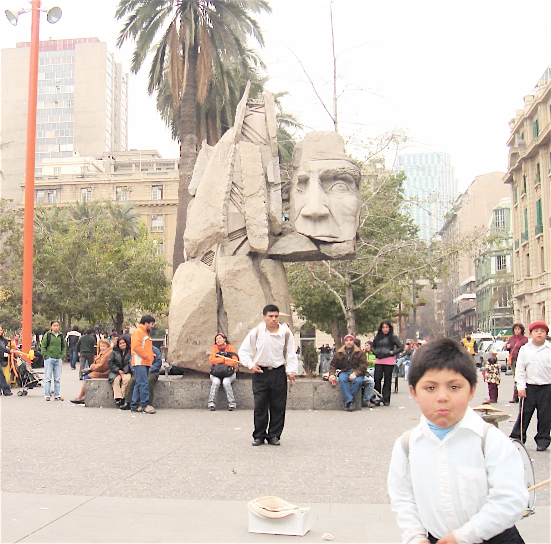 Near the center of Santiago. Palm trees, monuments, and street performers