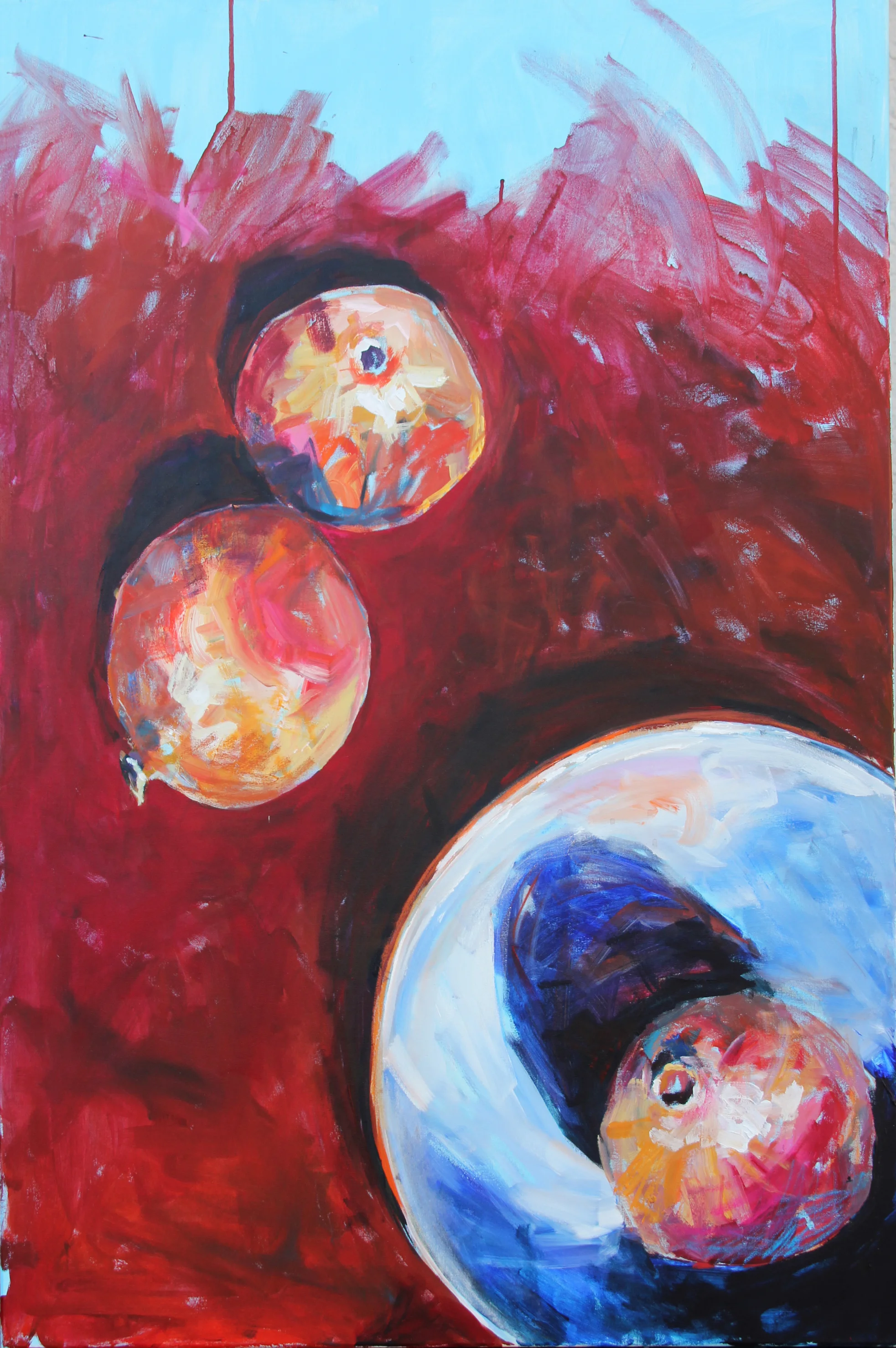 Three pomegranates and a blue bowl on a lacquer tray